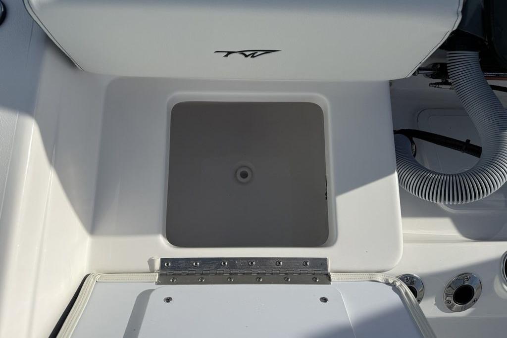 2026 Tidewater 198 CC Adventure boat storage compartment with hose and fittings.