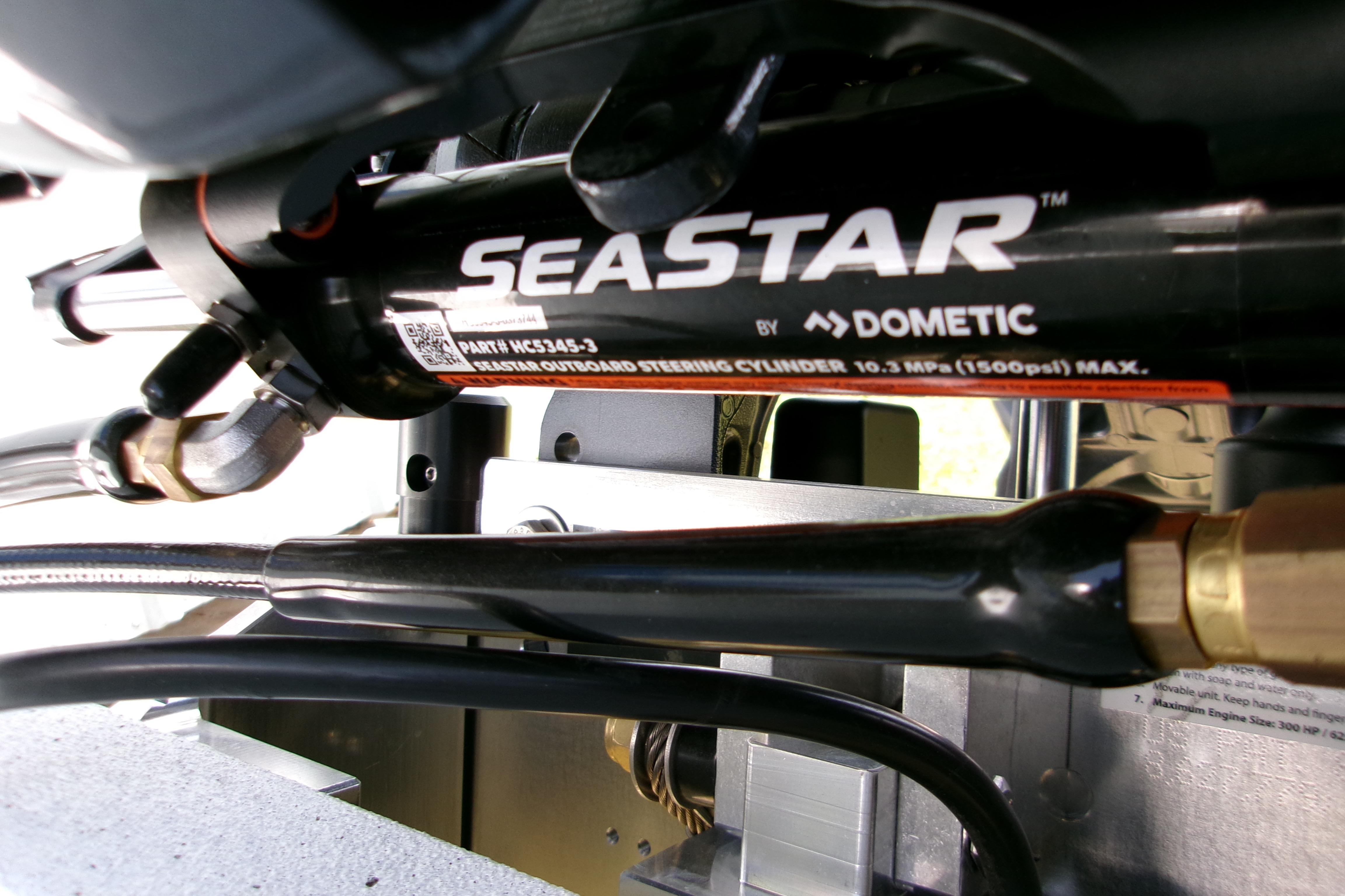 Close-up of SeaStar hydraulic steering system in 2027 Xpress H22B Bay boat.