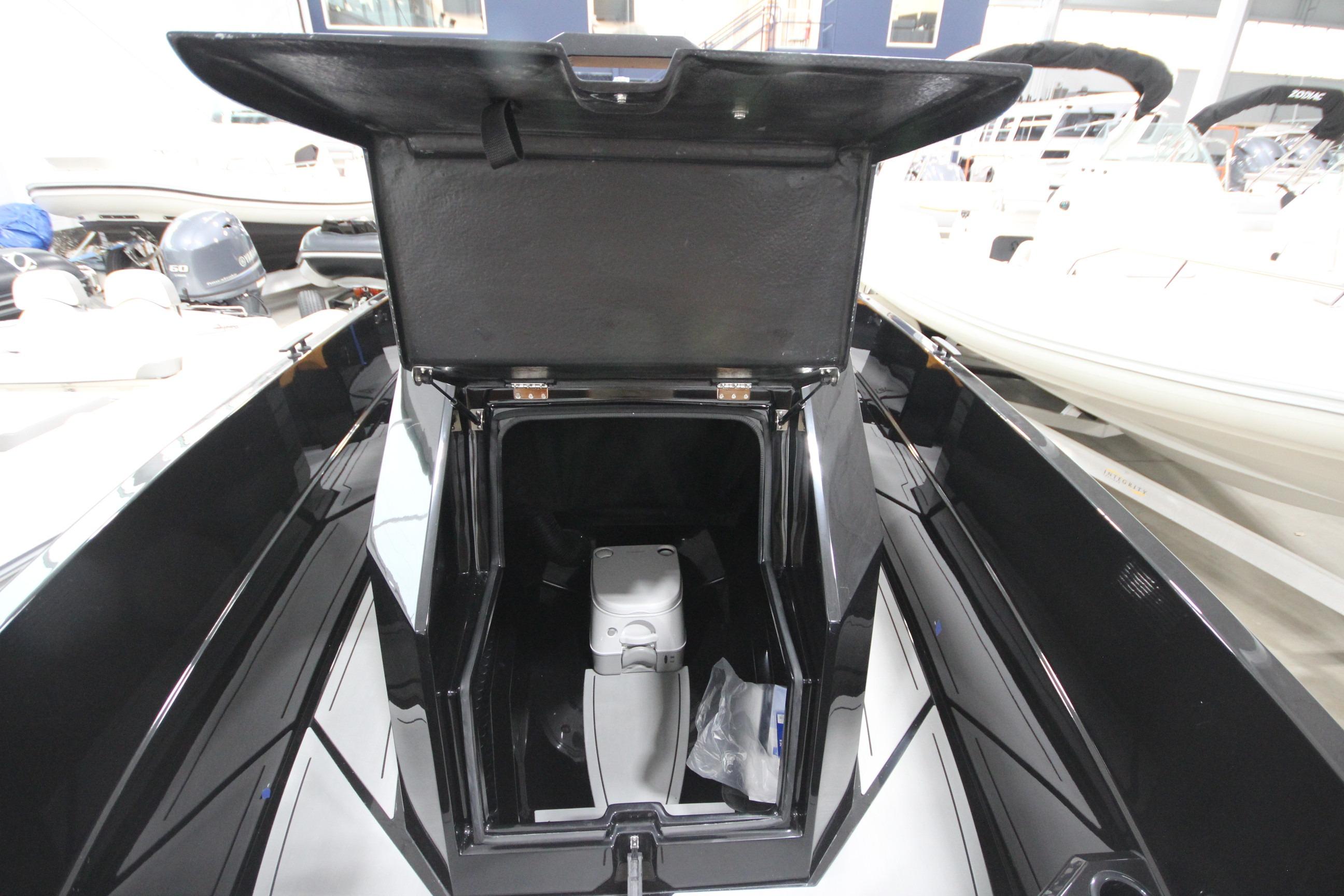 Open storage compartment on Iron 767 boat, showcasing interior space and design.