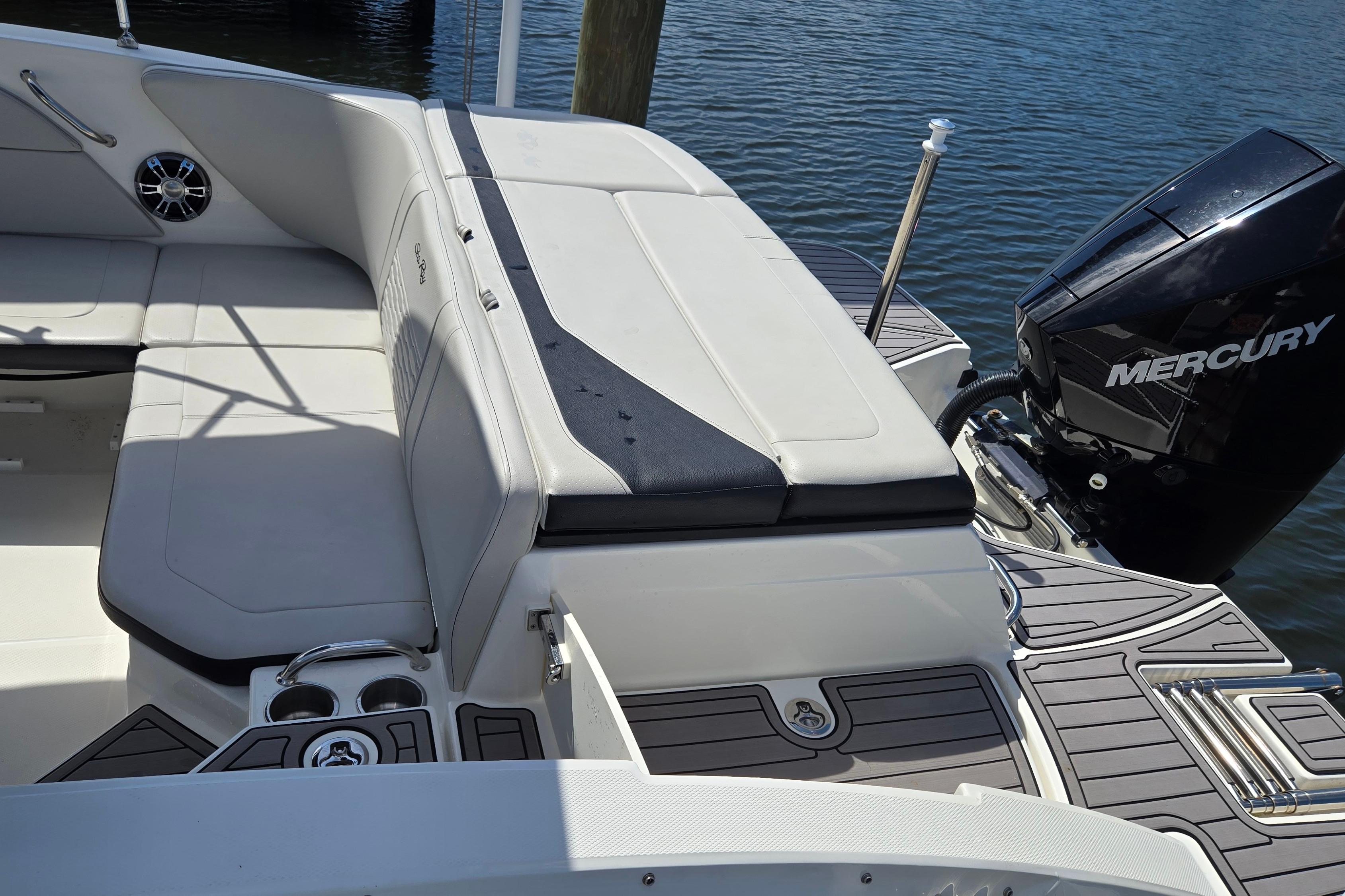 2023 Sea Ray SPX 210 boat interior with Mercury engine, featuring comfortable seating and cup holders.