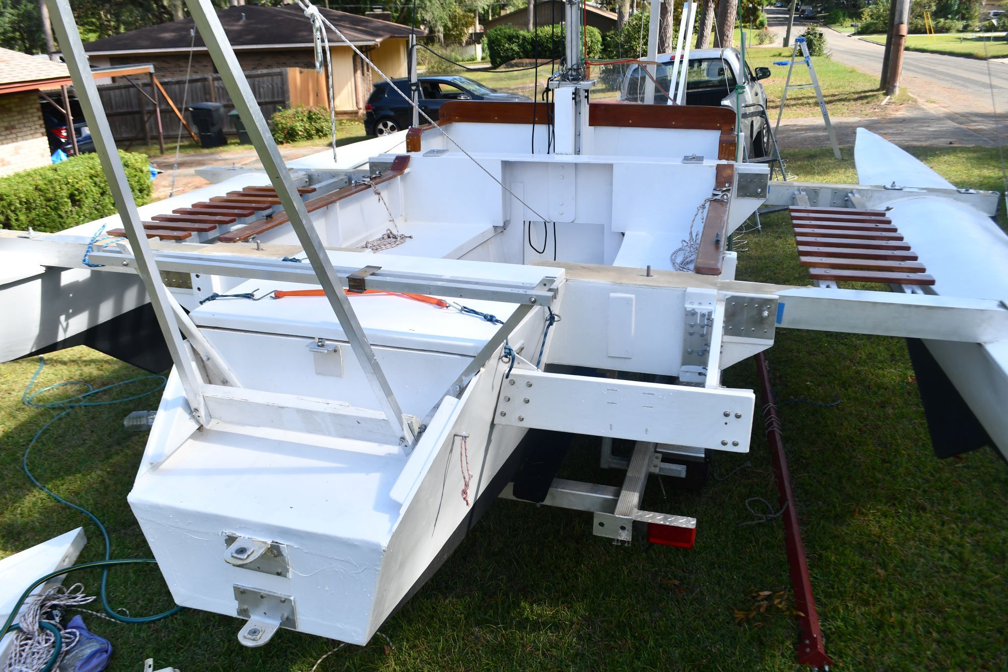 Custom Strike 18 trimaran from 2020 parked on grass.