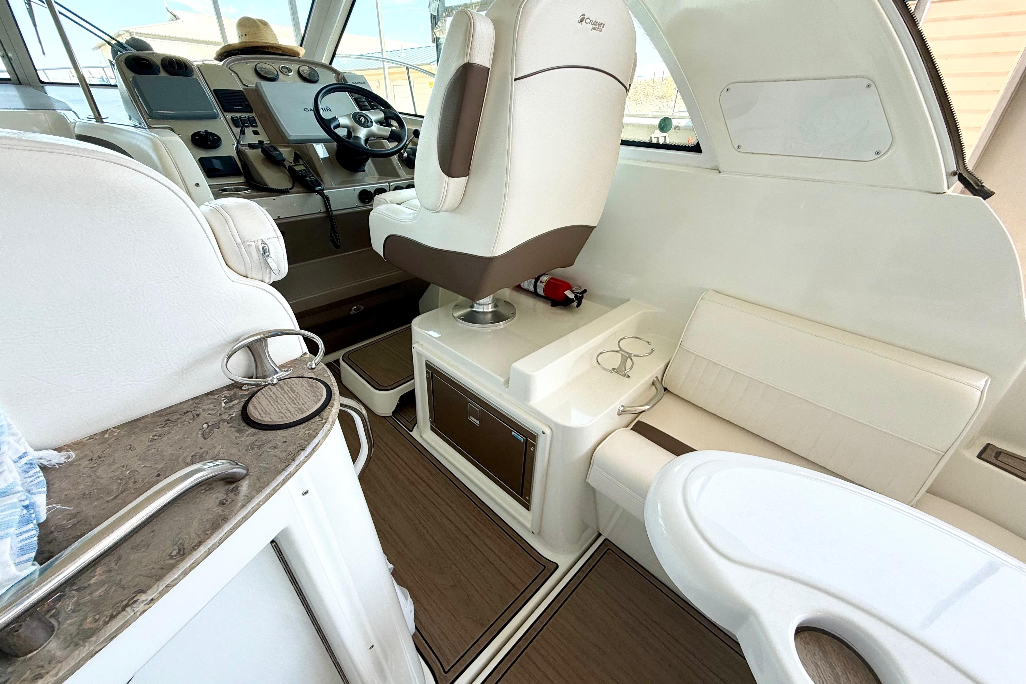 Interior of 2011 Cruisers Yachts 390 Sports Coupe with helm and seating area.