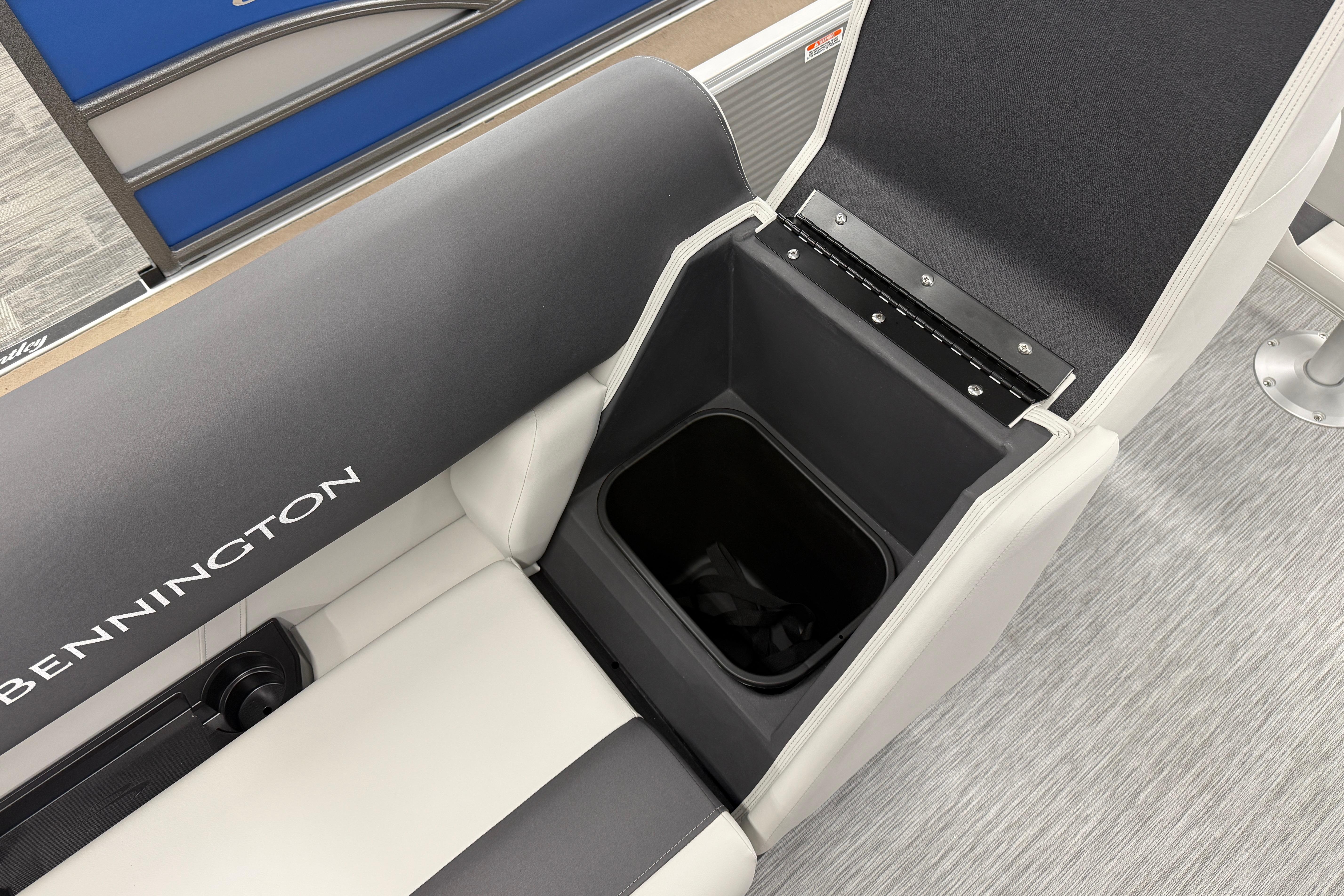 2026 Bennington 20 SF boat seat with storage compartment open, showcasing interior design.