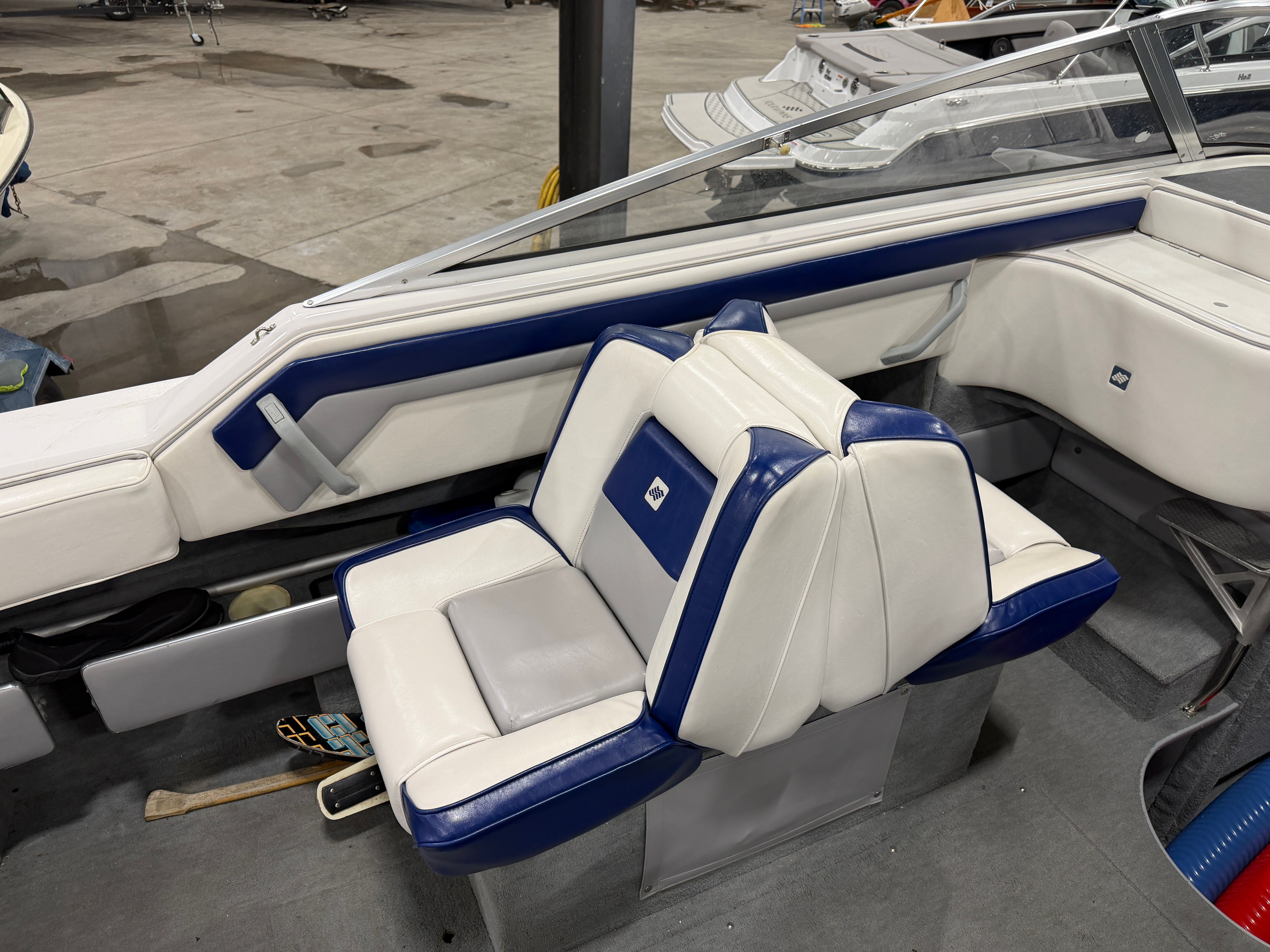 Interior of a 1992 Four Winns 225 Sundowner with blue and white seating.