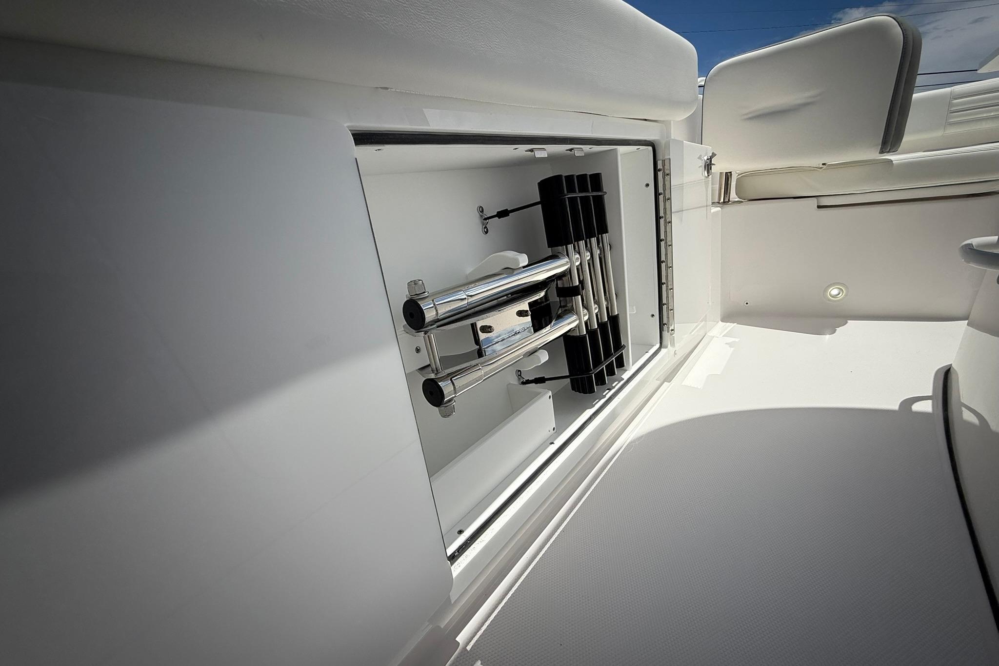 2026 Edgewater 250CC boat storage compartment with stainless steel fittings.