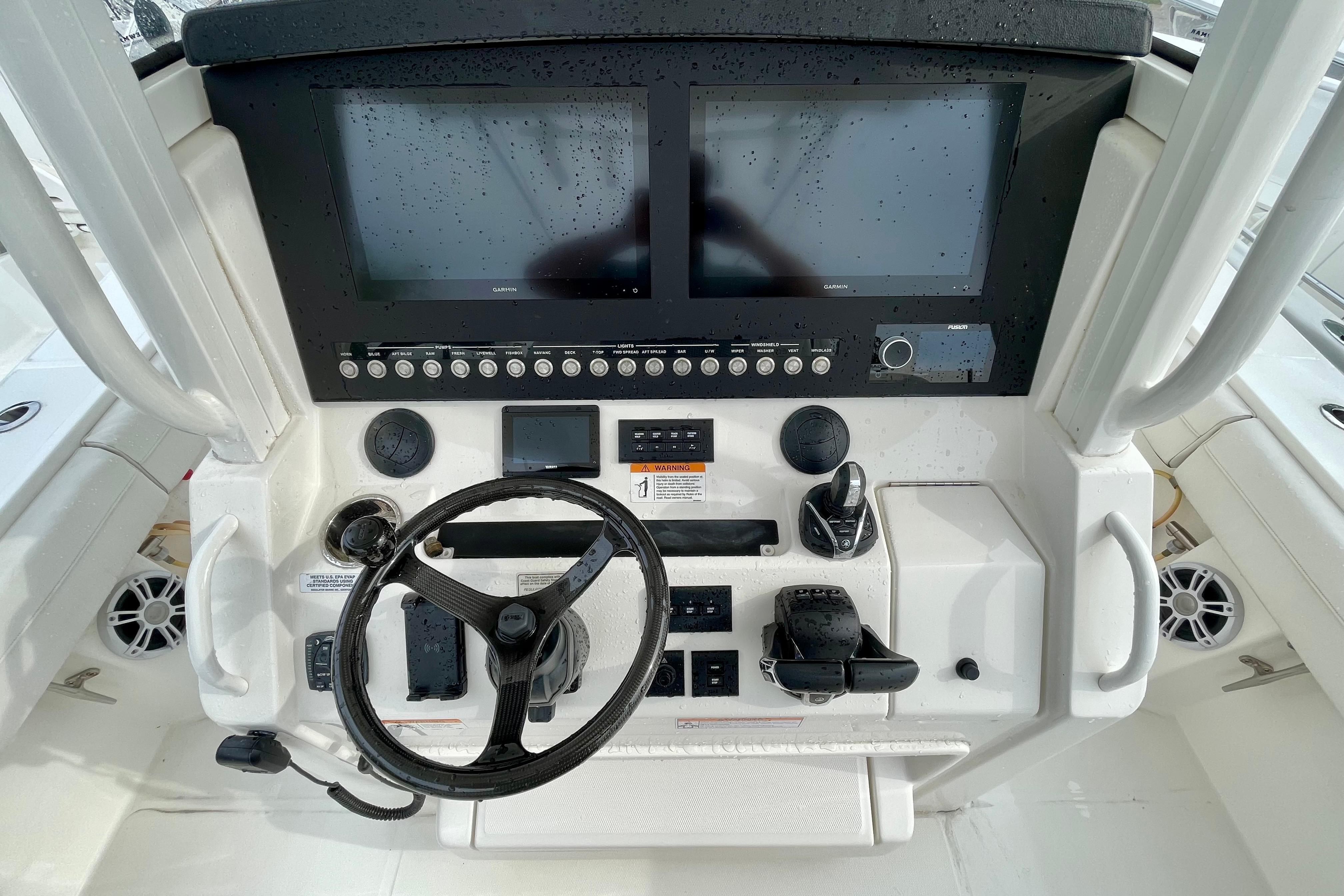 2023 Regulator 34 boat dashboard with dual screens and steering wheel.