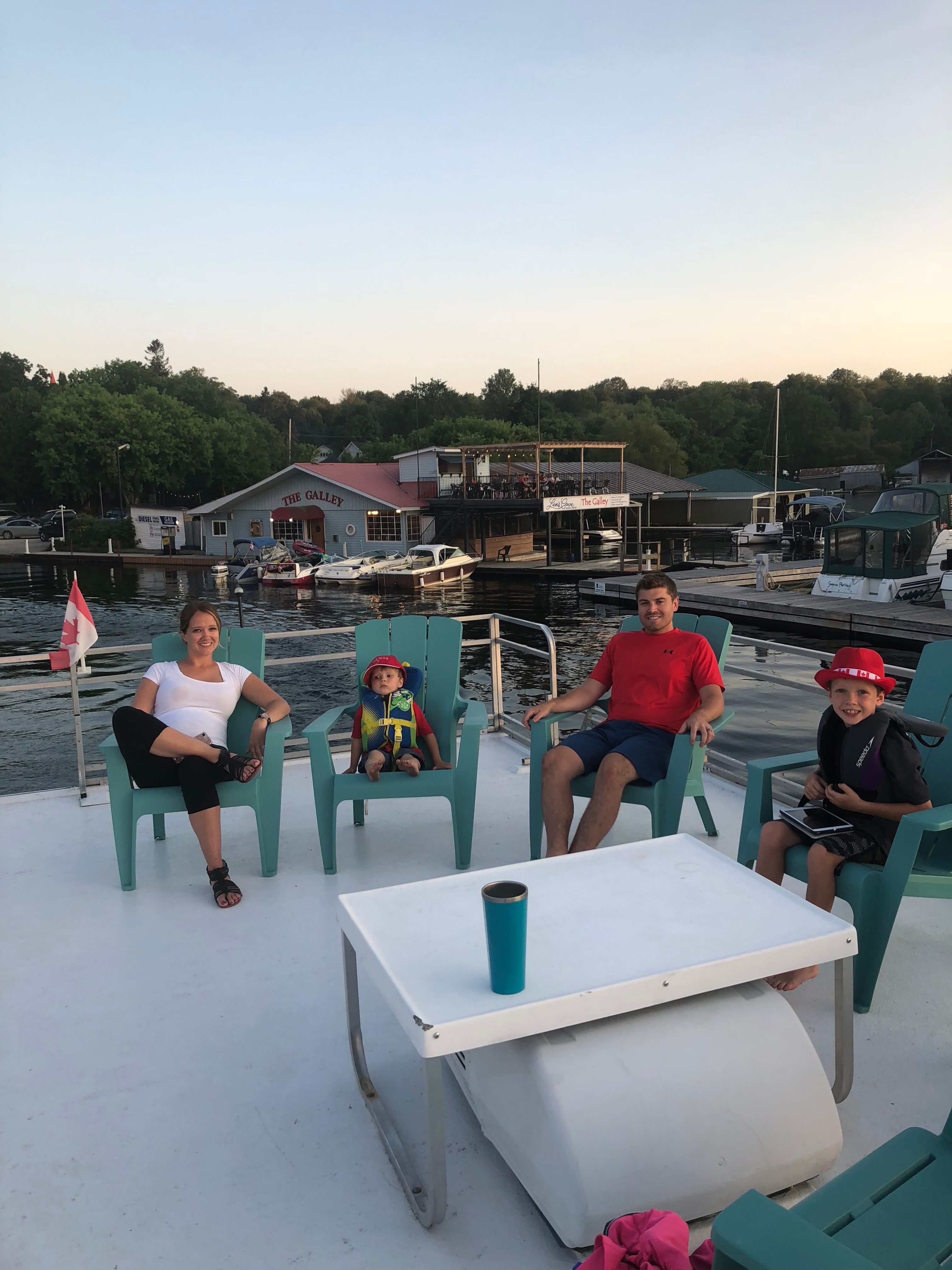 Family sitting on a catamaran overlooking the harbor.
