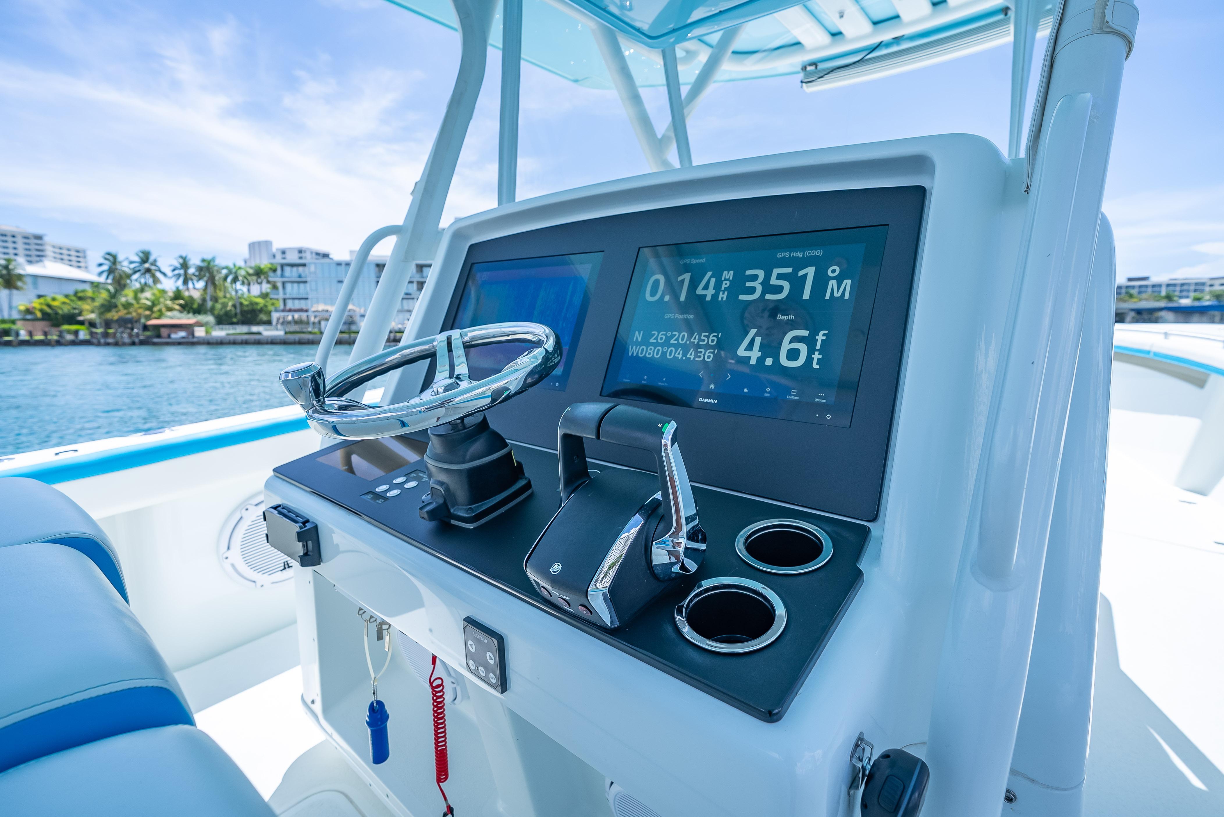 2016 Yellowfin 39 Offshore boat dashboard with navigation display and steering wheel.