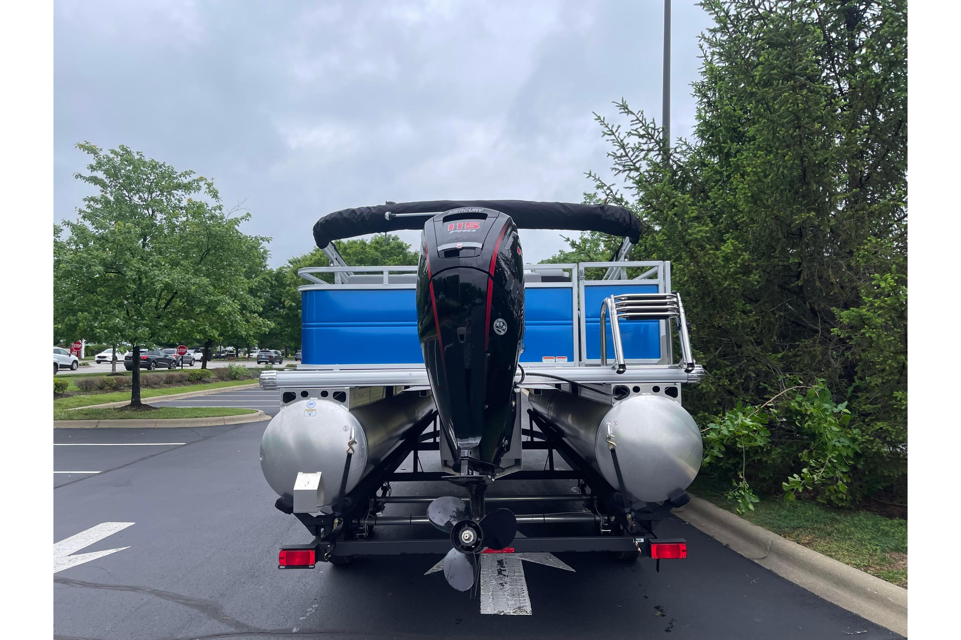 2026 Sun Tracker Party Barge 22 RF DLX pontoon boat parked outdoors.