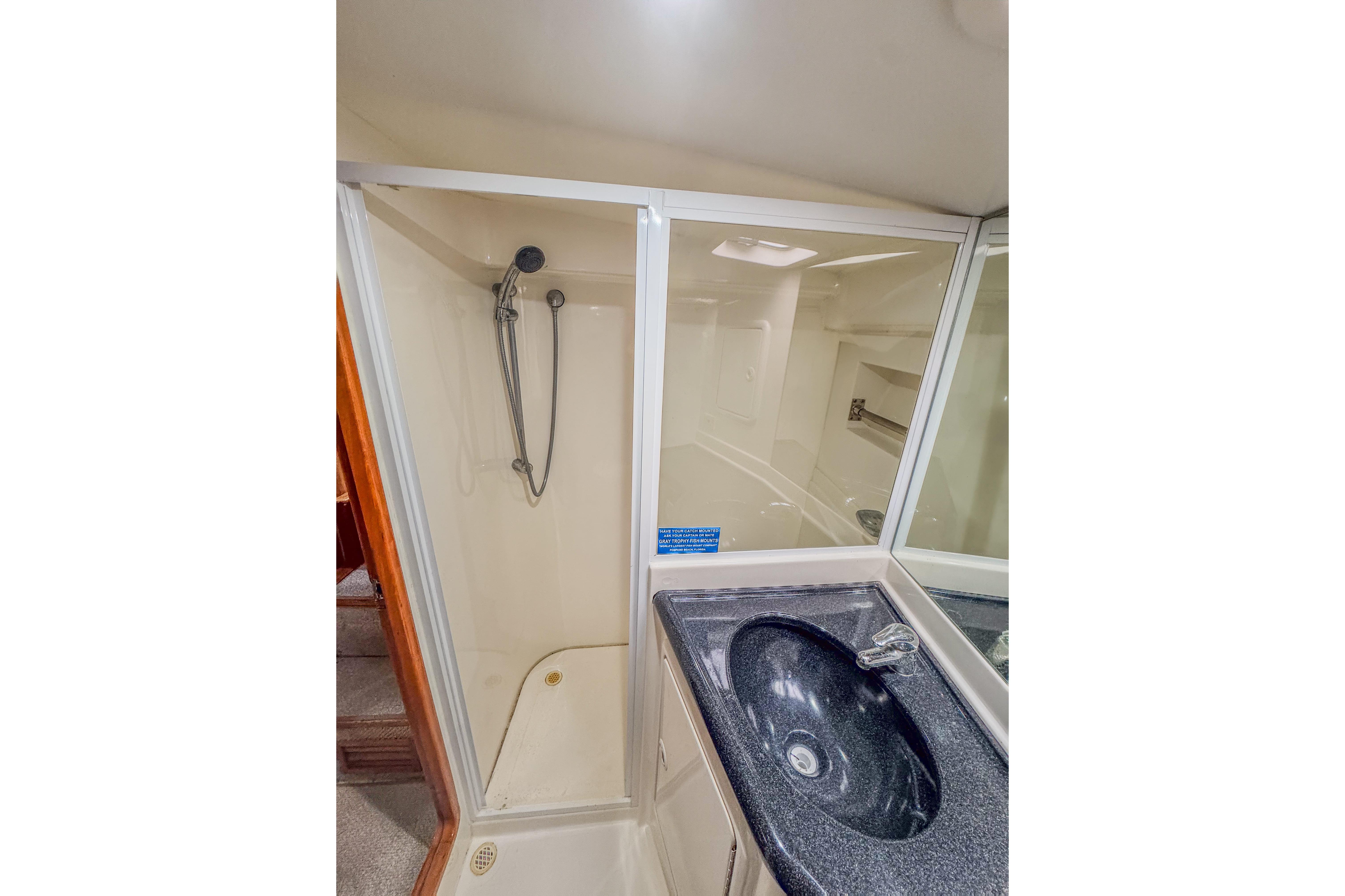 Bathroom interior of 2001 Black Watch 40 yacht with shower and sink.