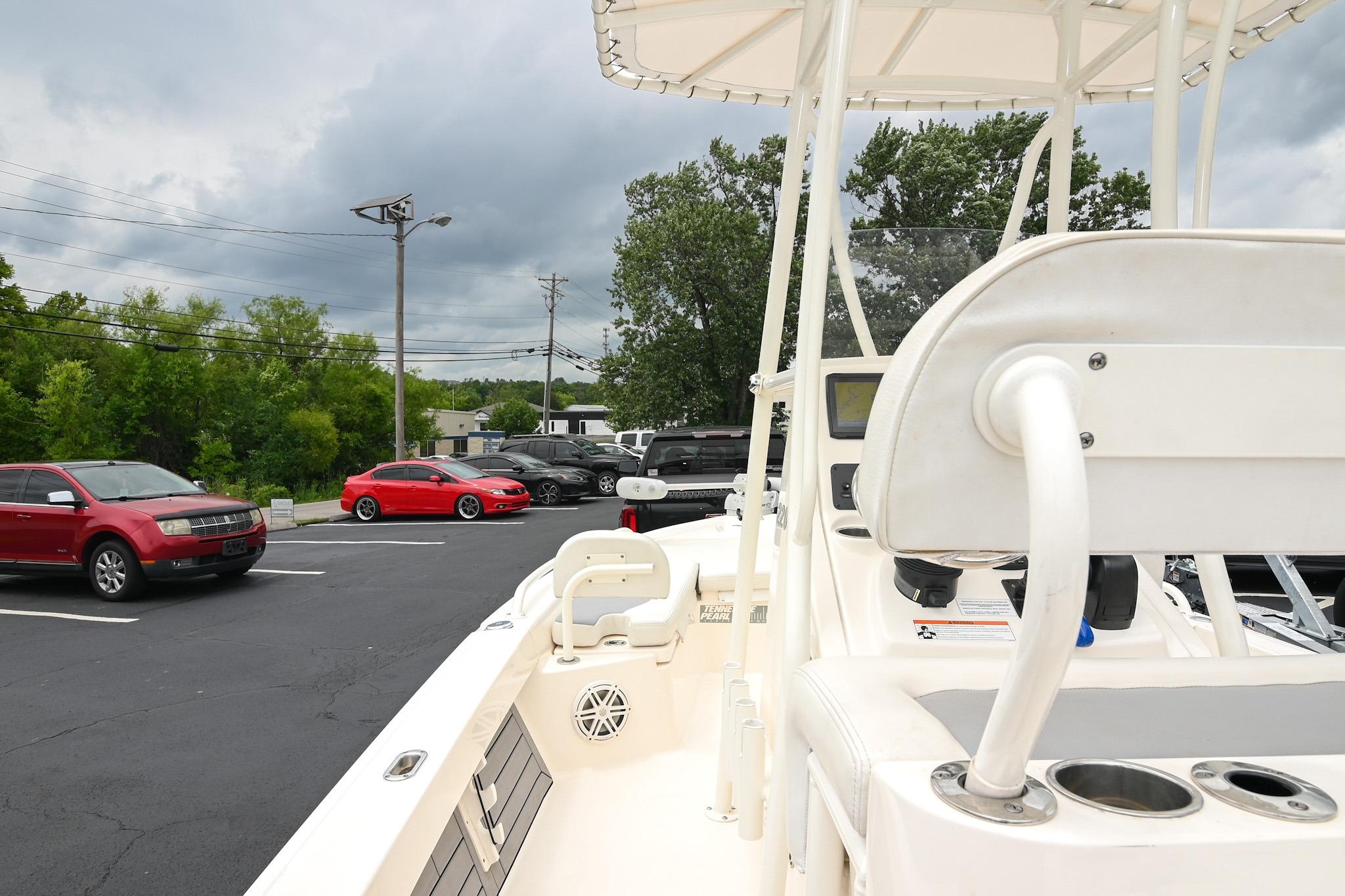 2021 Pathfinder 2200 TRS boat parked near cars under cloudy sky.
