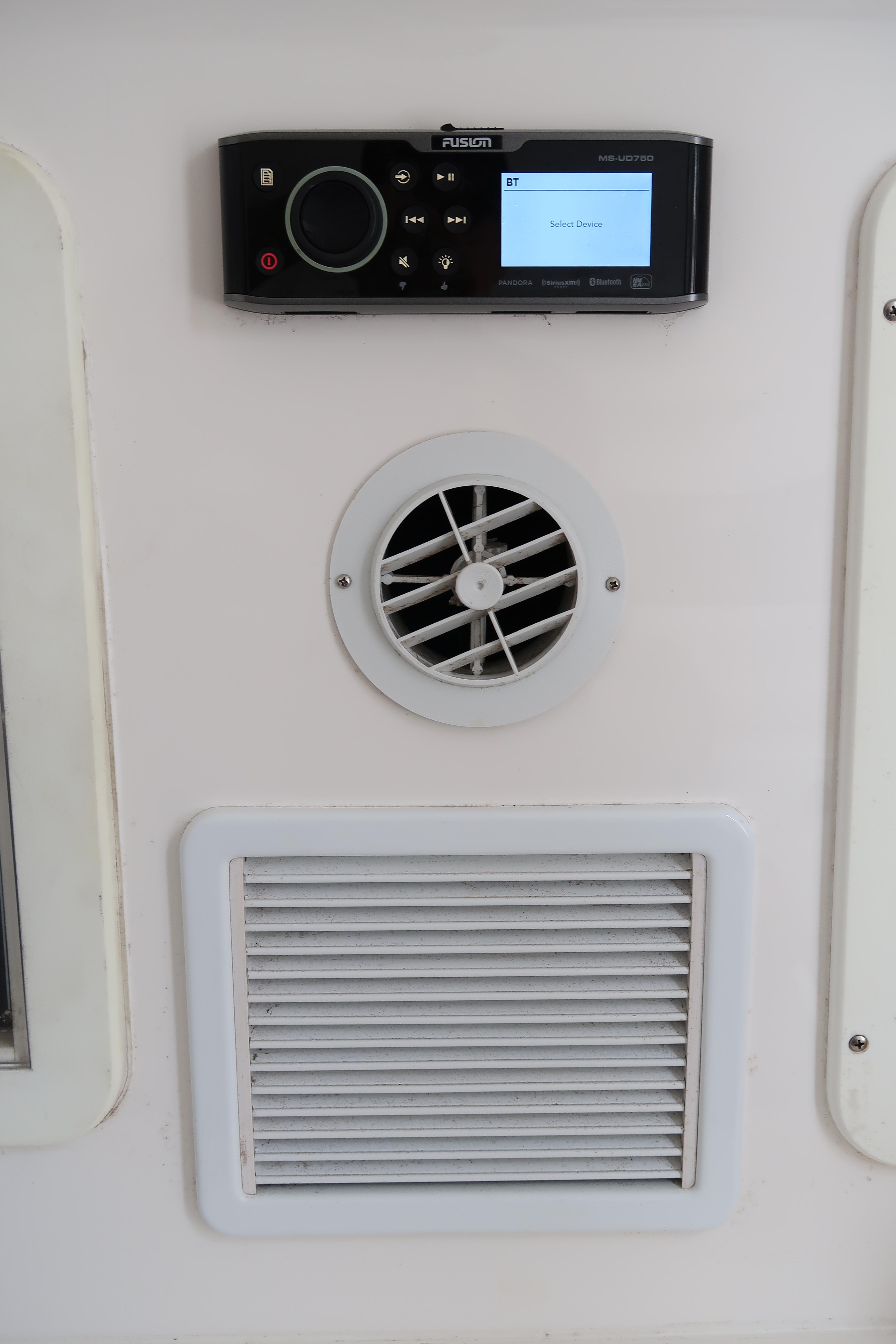 2016 Invincible 42 Open Fisherman control panel with air vents and audio system.