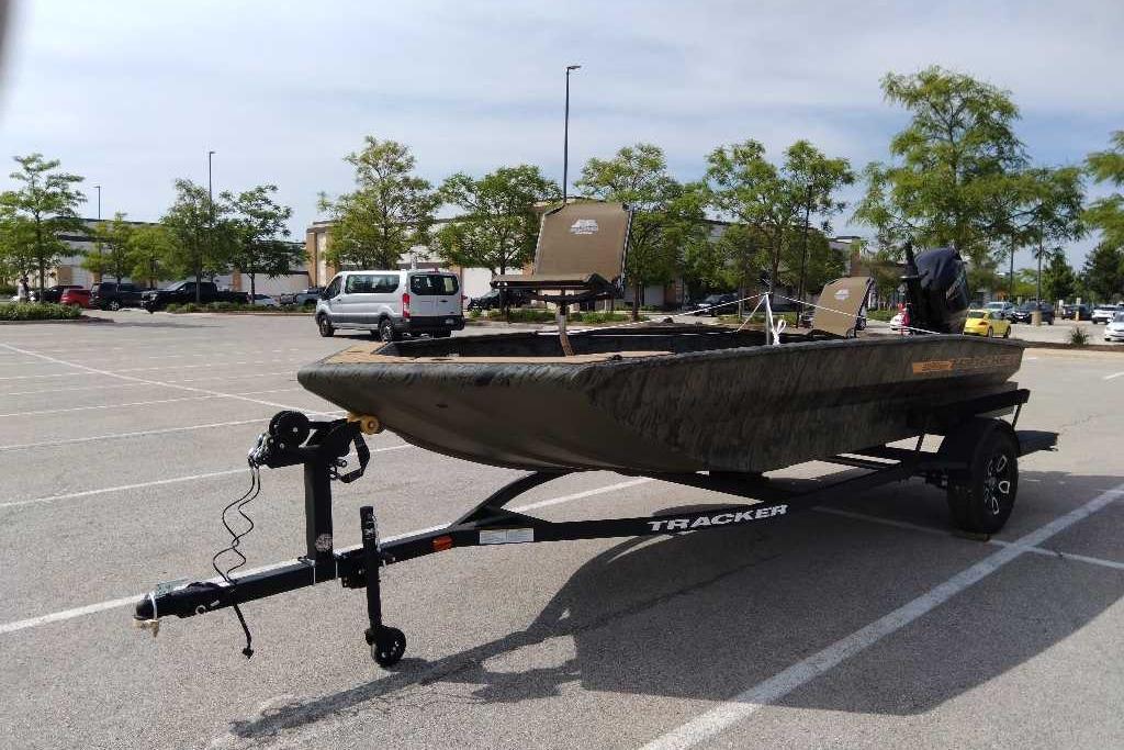2026 Tracker Grizzly 1756 T Marsh boat on trailer in parking lot.