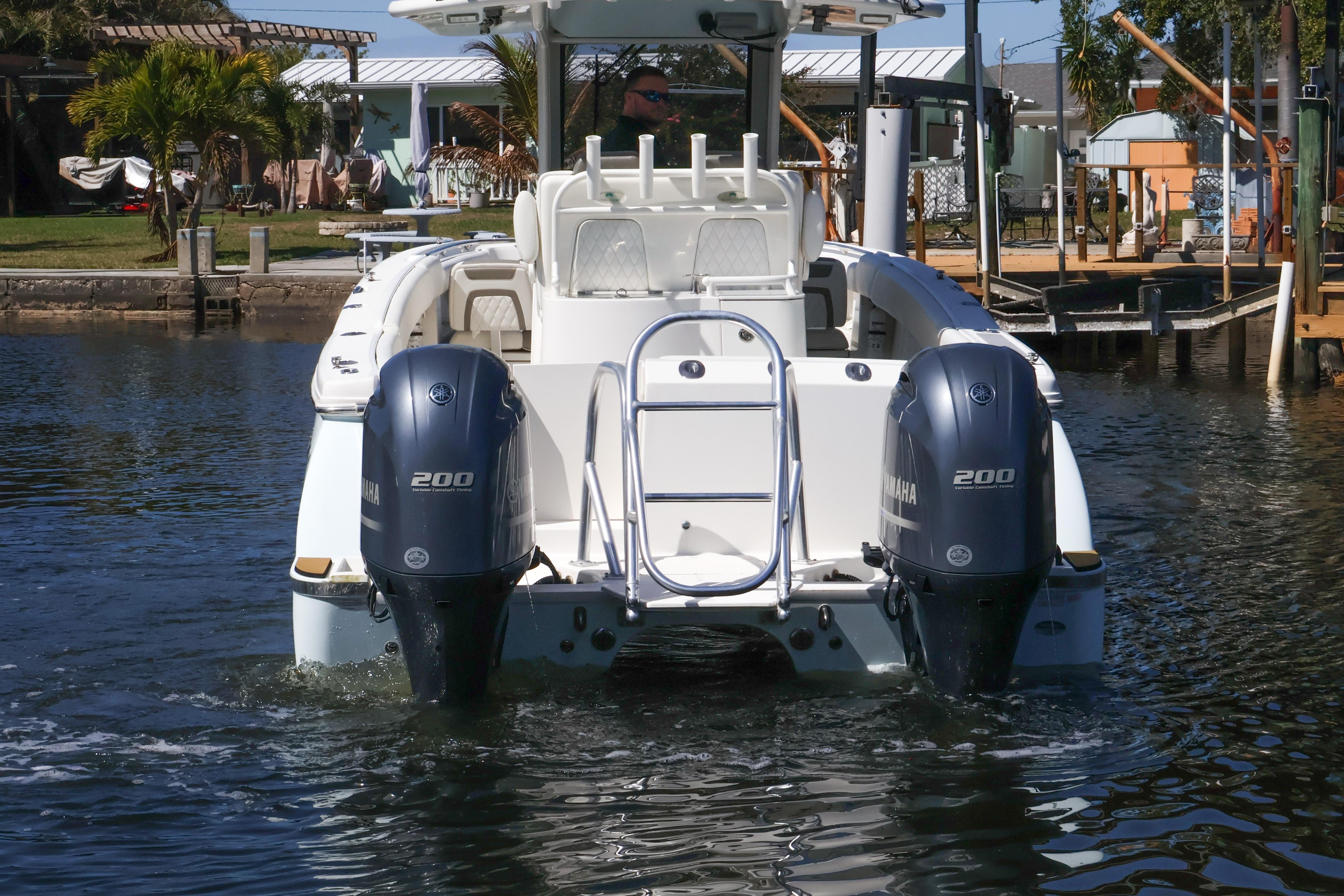 2022 World Cat 280 CC-X boat with dual Yamaha 200 engines on water.