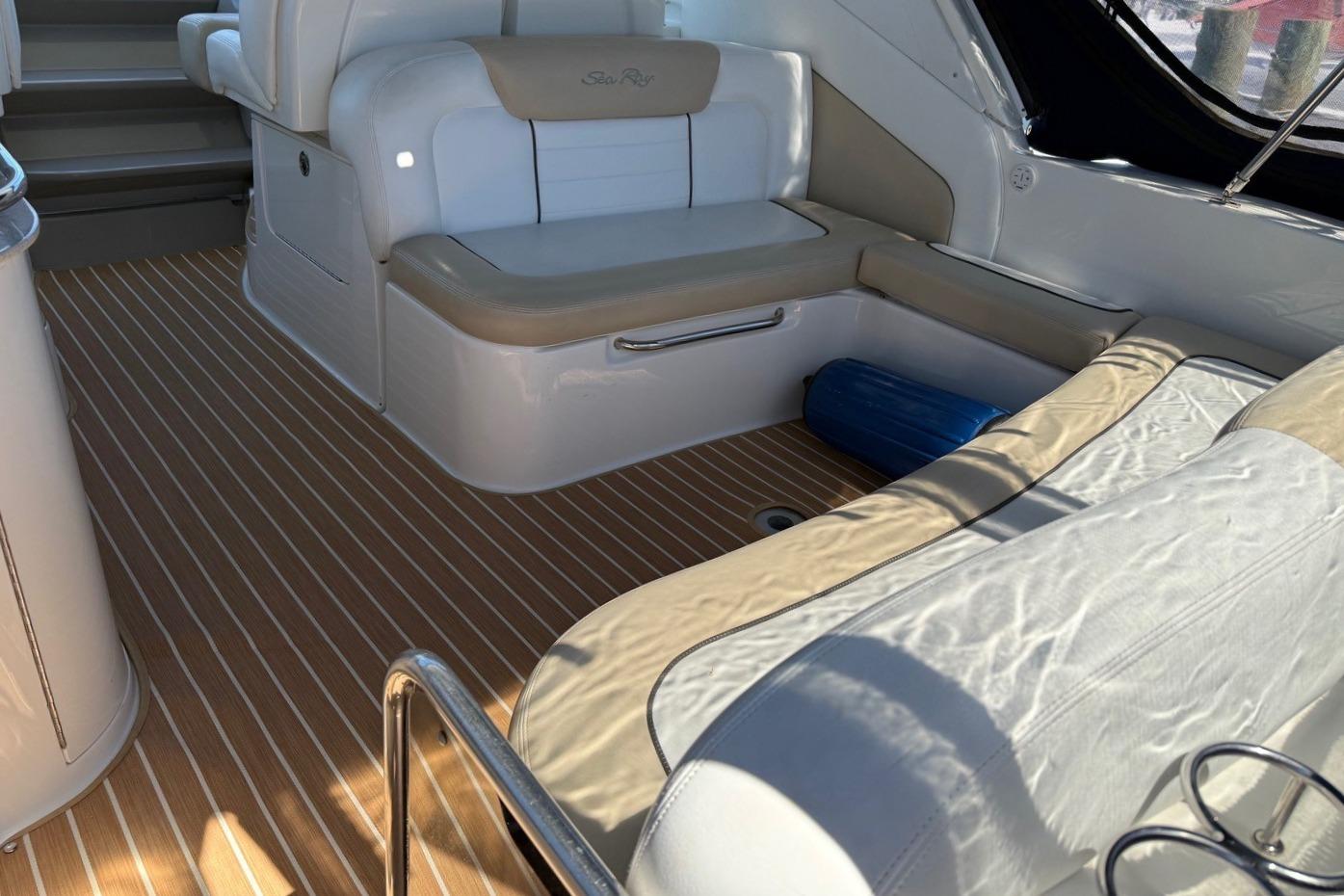 Interior of 2008 Sea Ray Sundancer 330 with white seating and wood-patterned flooring.