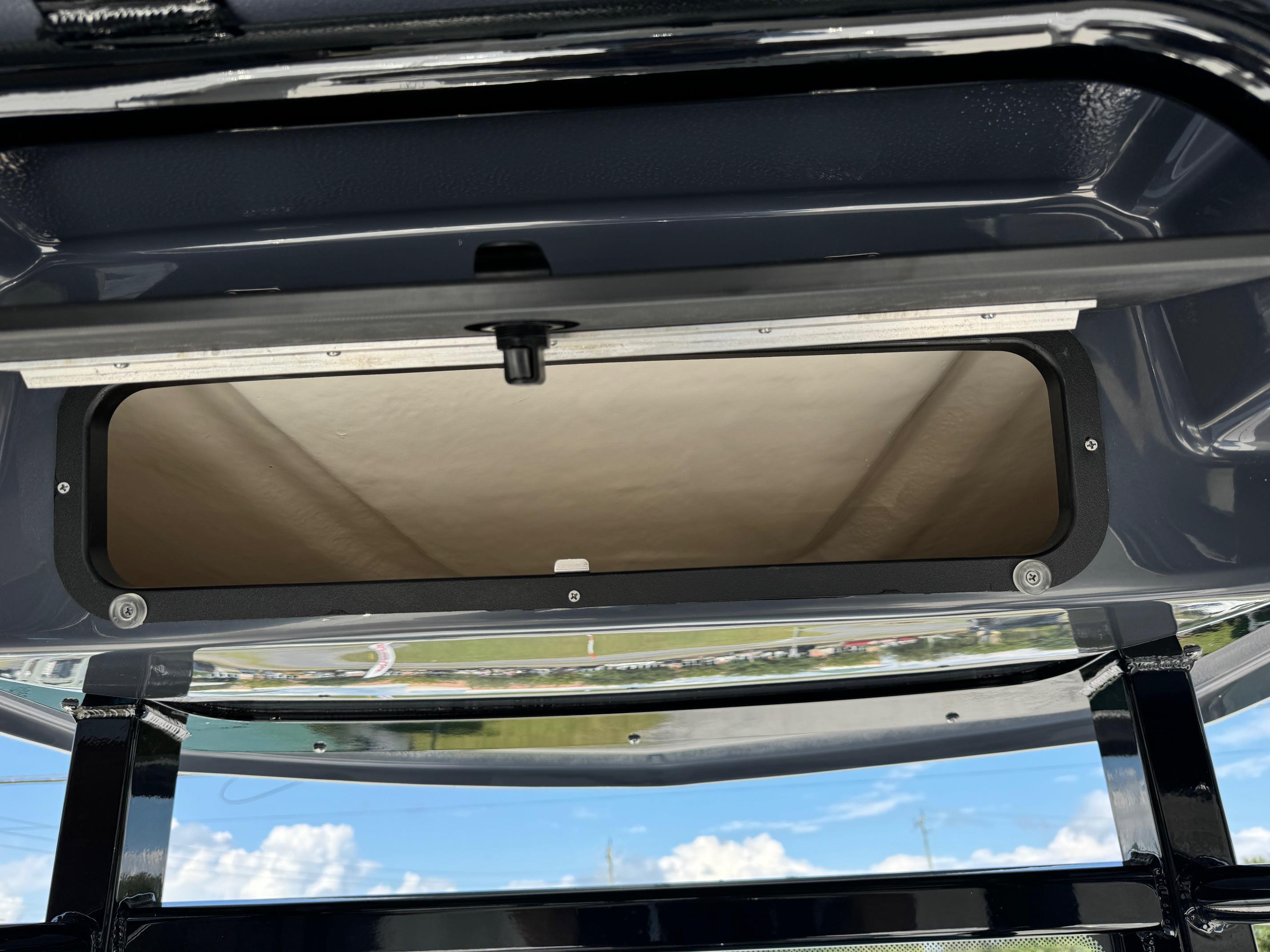 2025 Robalo R246 CAYMAN boat storage compartment with open hatch, showcasing interior details.