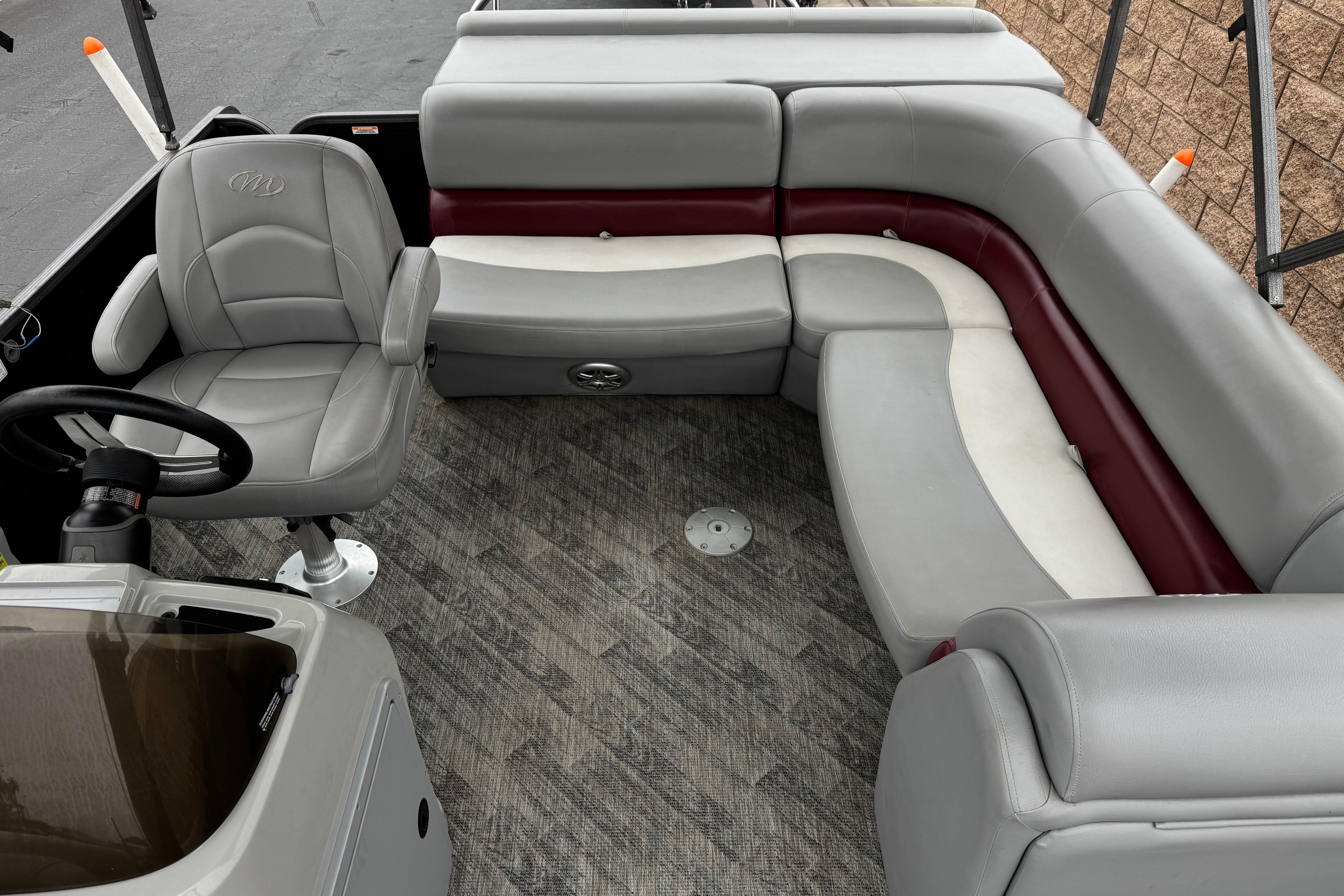 2020 Manitou 18 Aurora LE pontoon boat interior with gray and maroon seating.