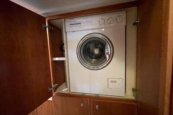Washing machine inside a 2000 Silverton 453 Motor Yacht wooden cabinet.