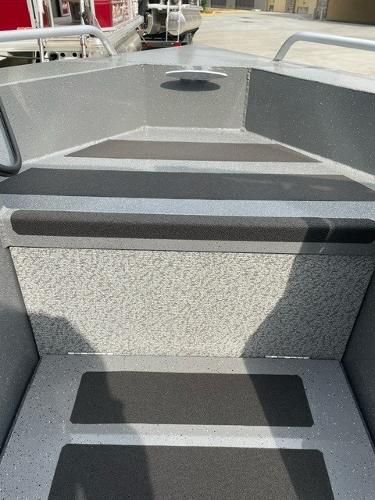 2025 Spartan 200 Astoria boat interior with gray textured flooring and seating.