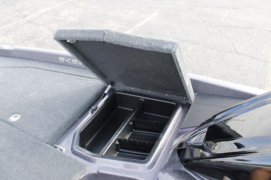 Open storage compartment on 2026 Skeeter ZXE20 boat, showcasing interior space.