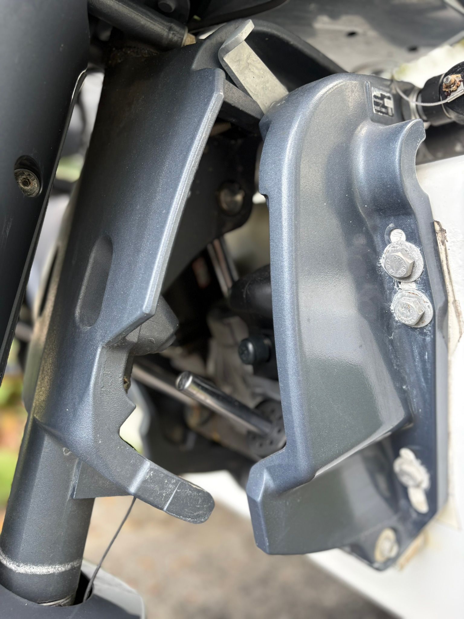Close-up of a boat's outboard motor with gray metal components.