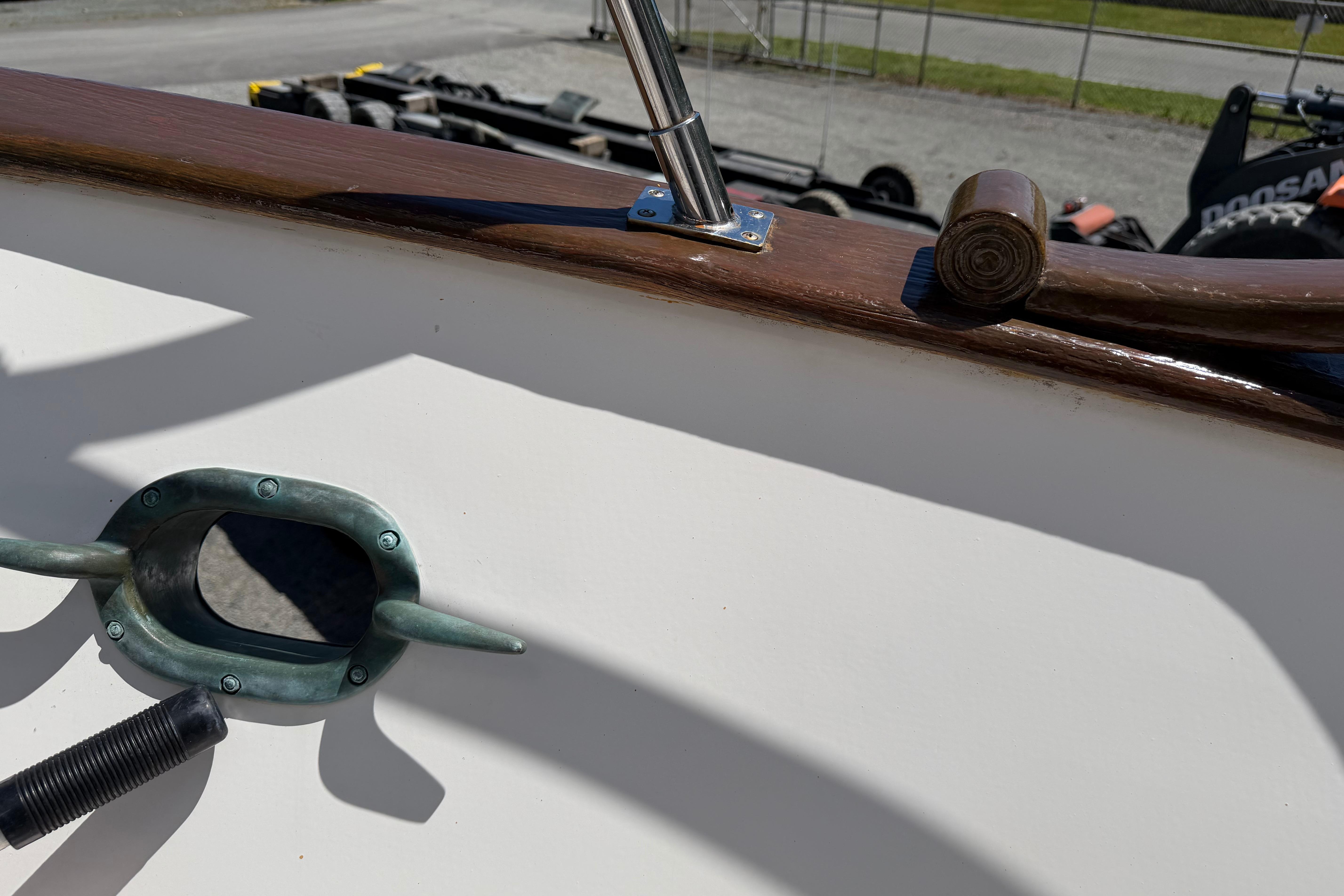 1987 Marine Trader 36 boat detail with cleat and polished wood railing.