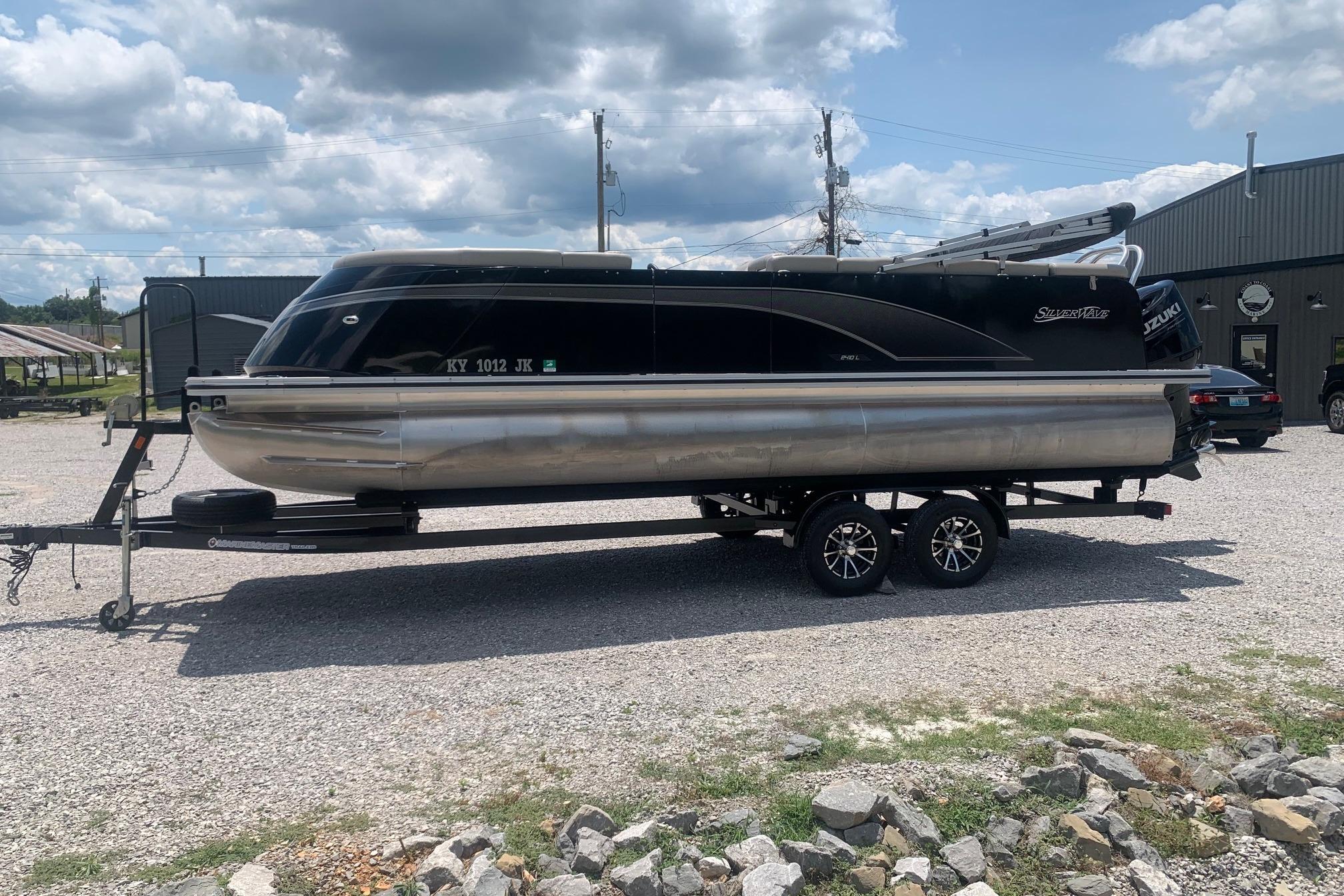 2023 Silver Wave 2410 SW3 CLS pontoon boat on trailer, parked outdoors.