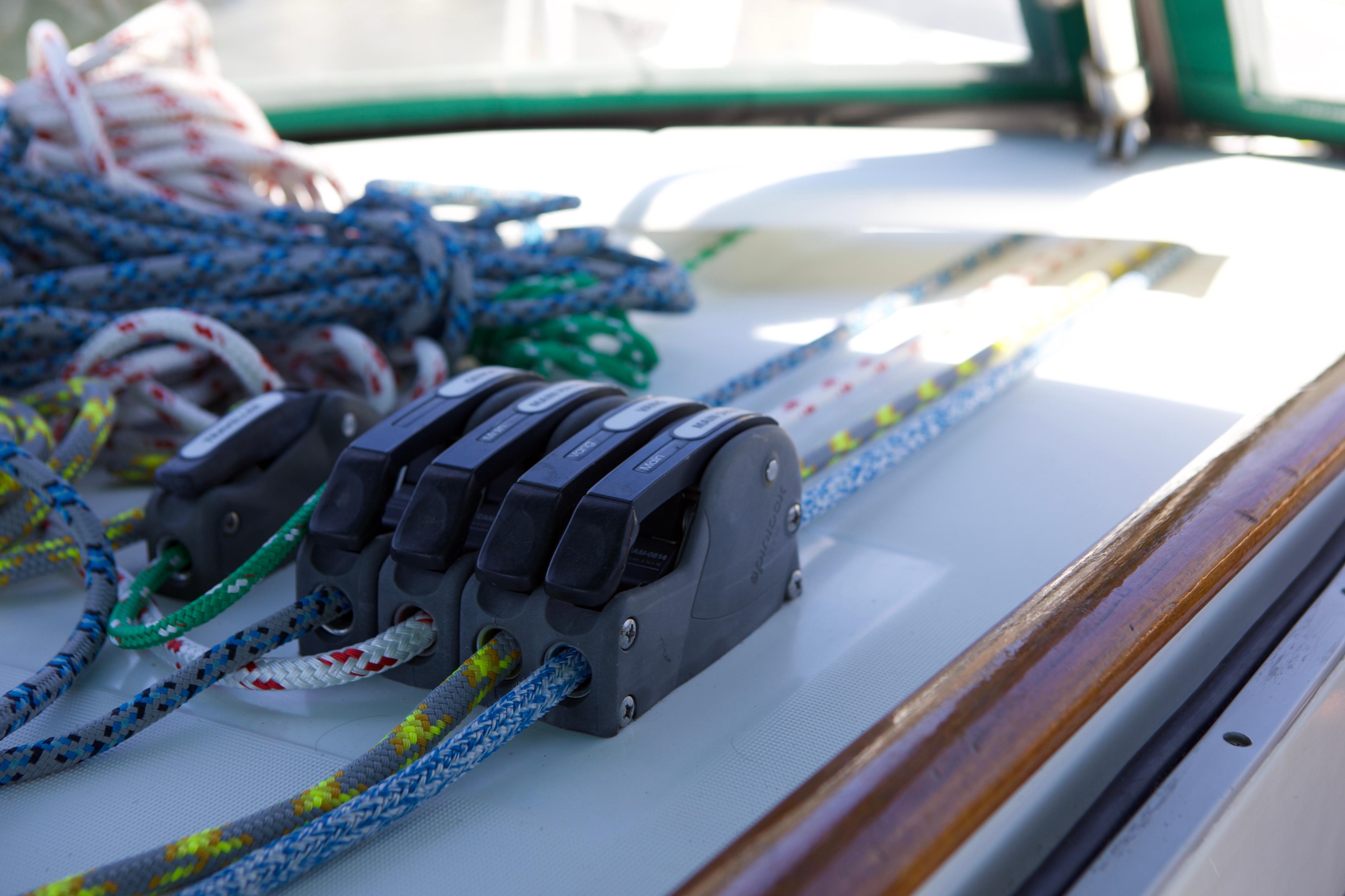 Close-up of sailing ropes and clutches on a 2005 Beneteau 423 yacht deck.