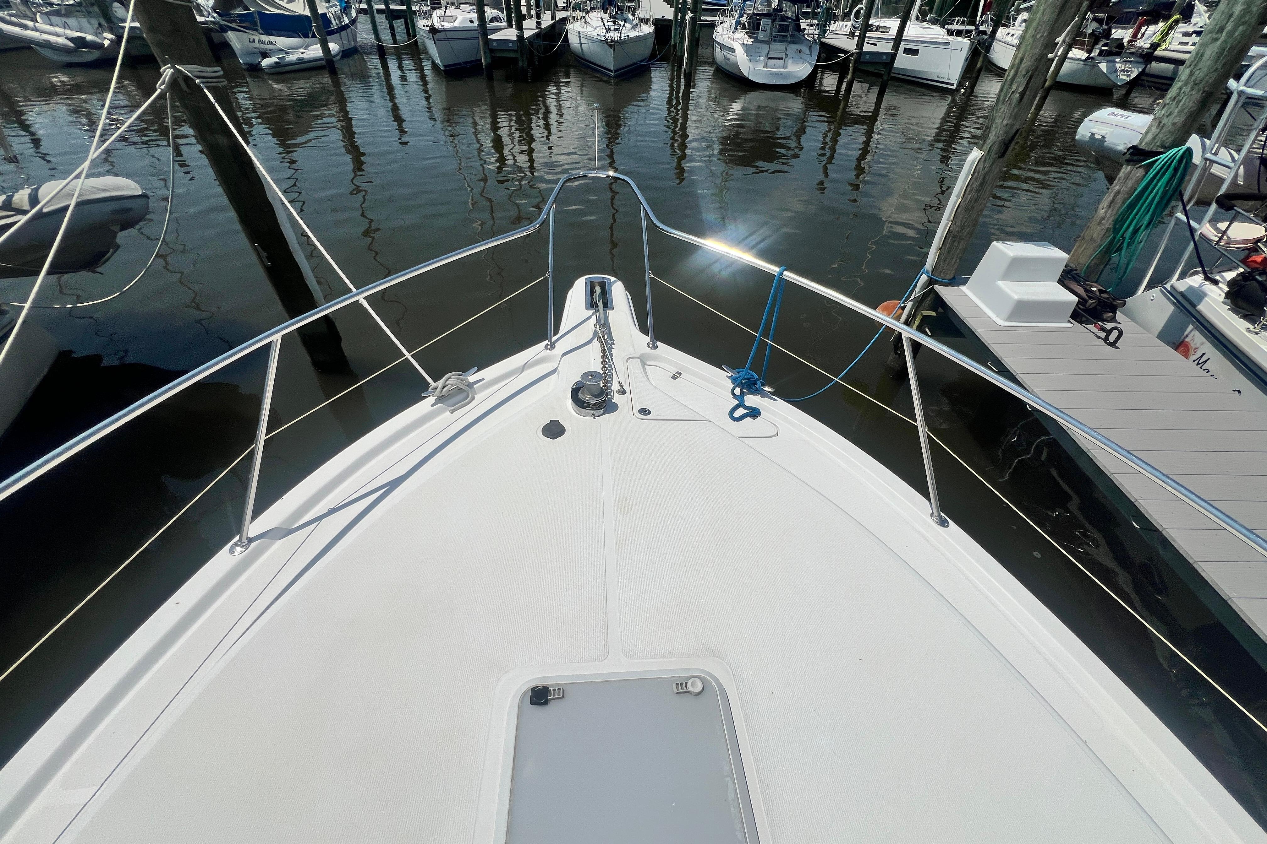 Bow view of 2007 Riviera 33 Flybridge yacht docked at marina.
