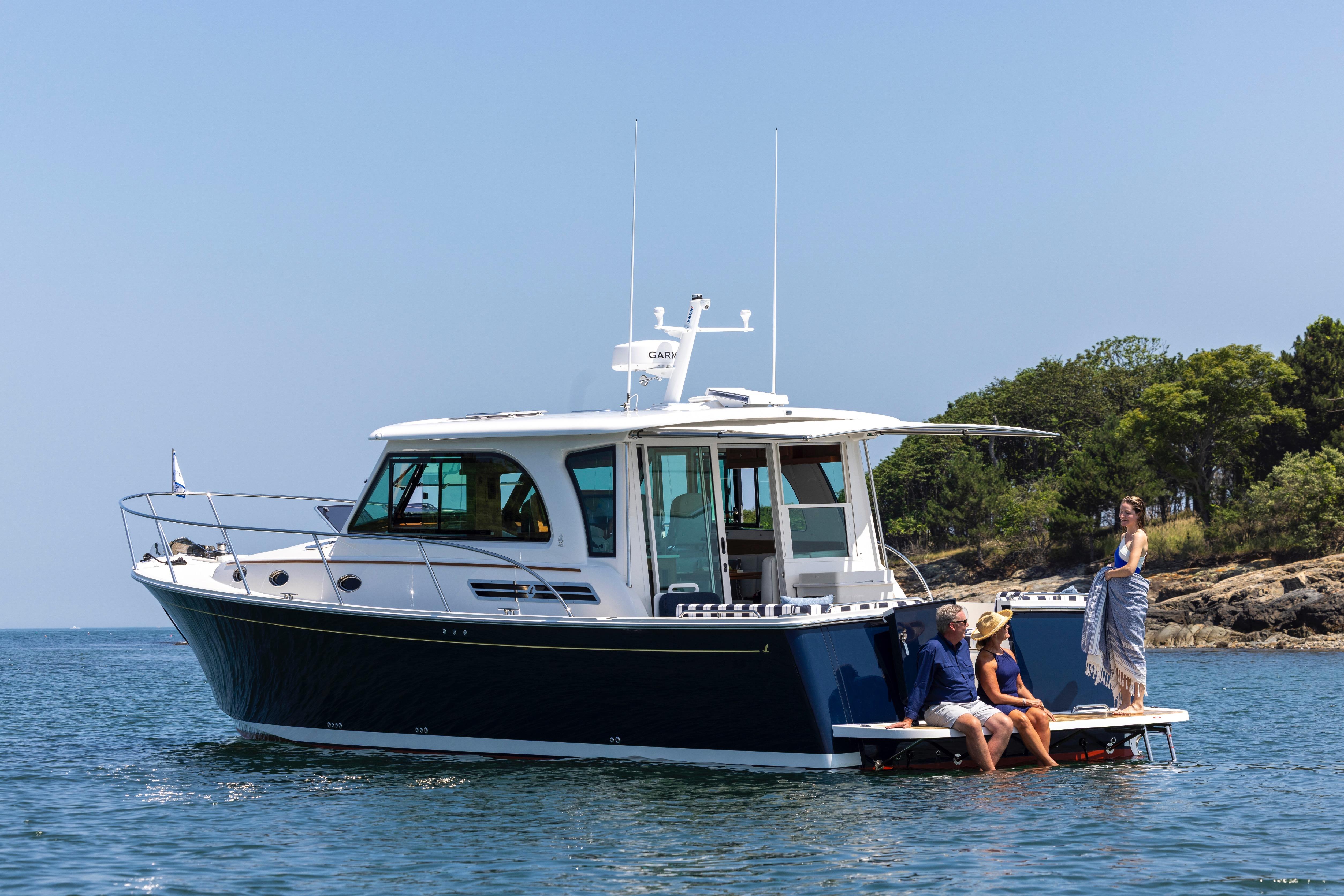 2027 Back Cove 412 yacht on water with people enjoying the sun.