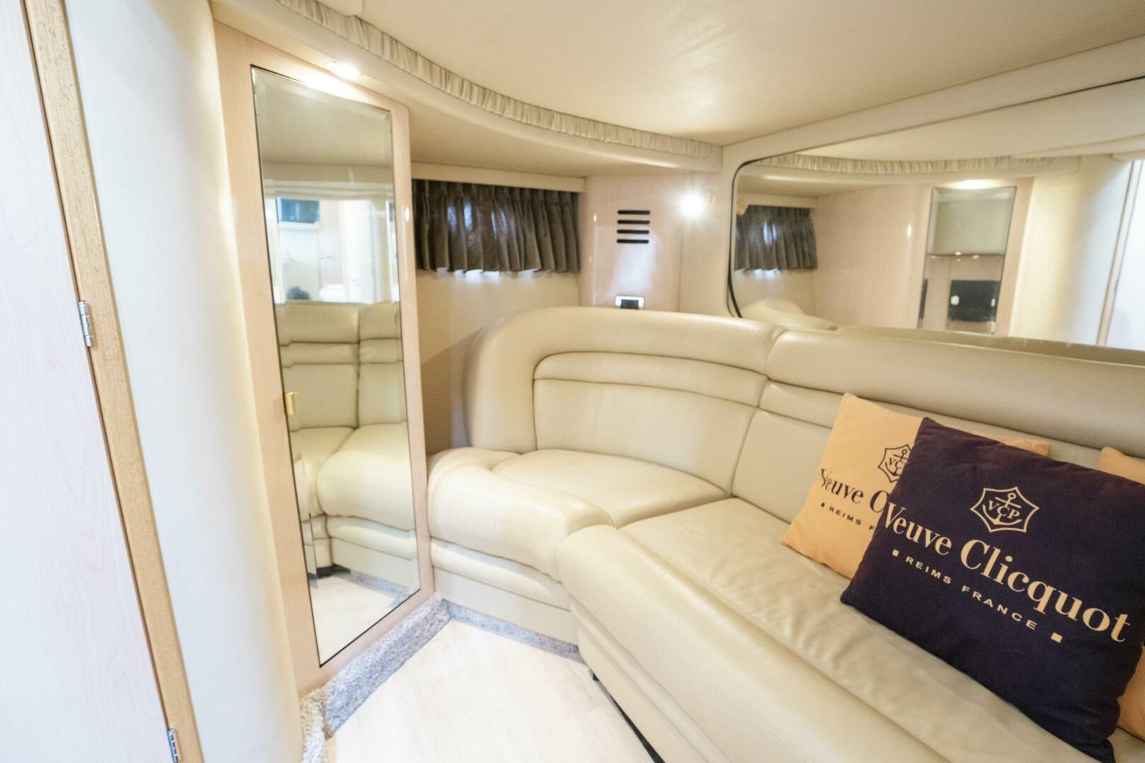 Luxurious interior of 2003 Sea Ray Sundancer 460 yacht with plush seating and elegant decor.