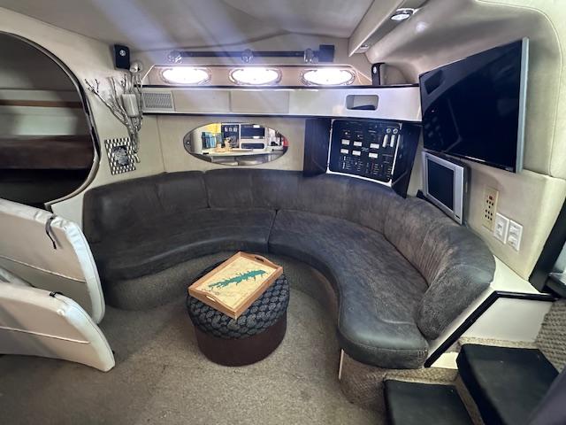 Interior of 1995 Sea Ray 400 Express Cruiser with curved seating and modern amenities.