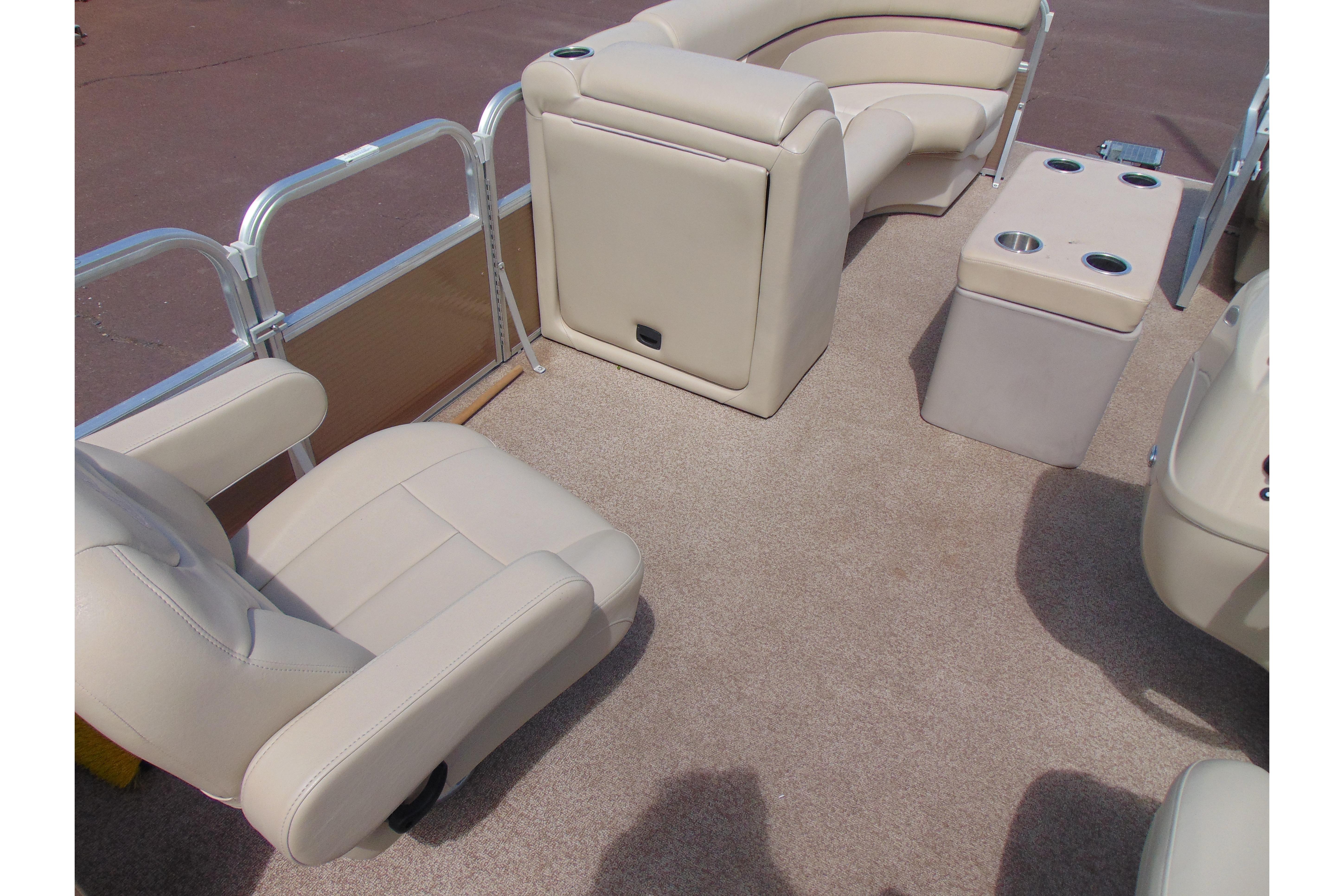 Interior of 2016 Misty Harbor 245 Adventure CU pontoon boat with beige seating and carpet.