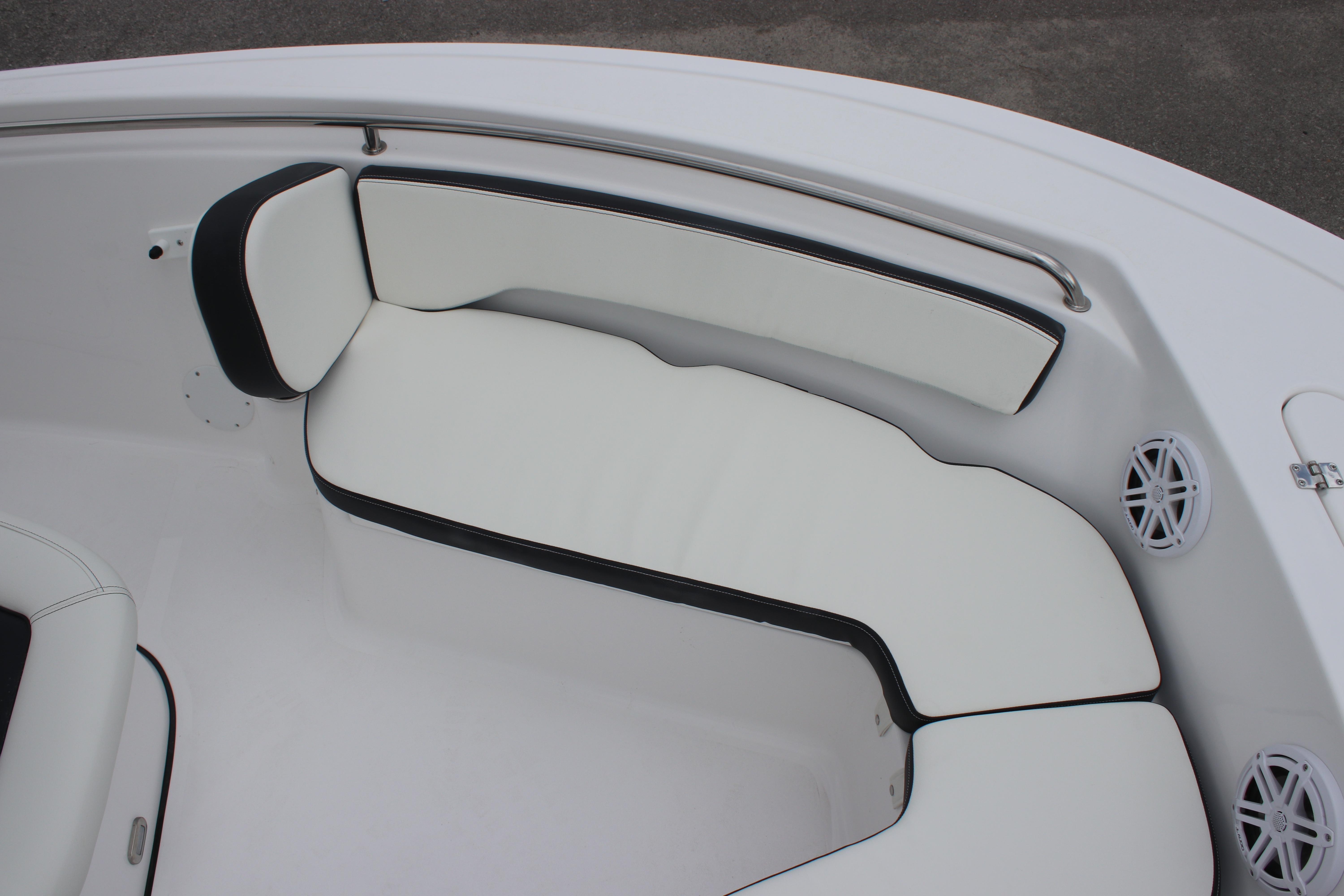 2026 Tidewater 198 CC Adventure boat interior with white cushioned seating and speakers.
