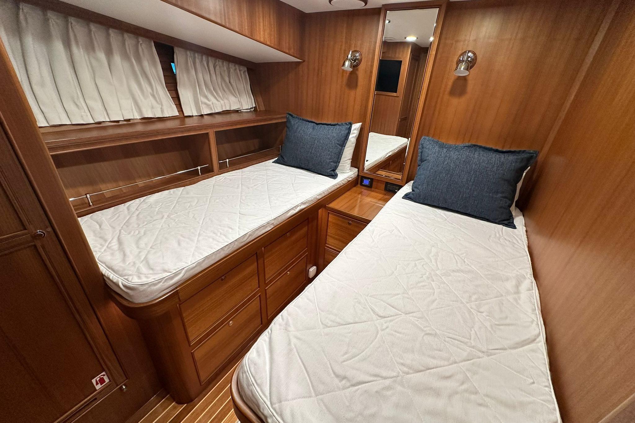 2023 Marlow Explorer 66E-CB cabin with twin beds, wooden interior, and cozy decor.