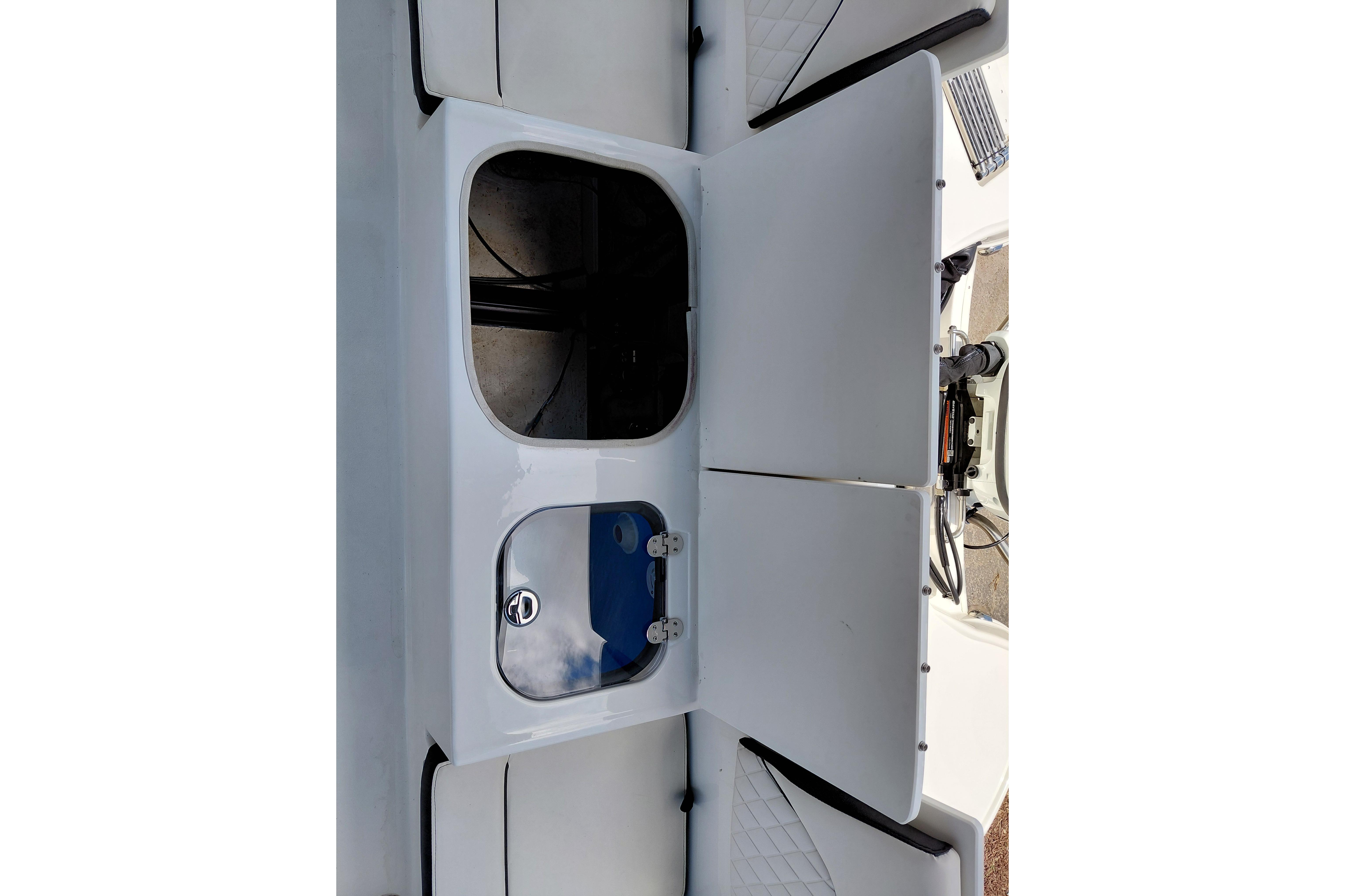 2023 Stingray 206 CC boat storage compartments with open hatches, showcasing interior space.