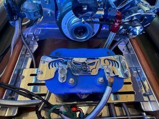 Close-up of a boat engine with blue and metallic components.