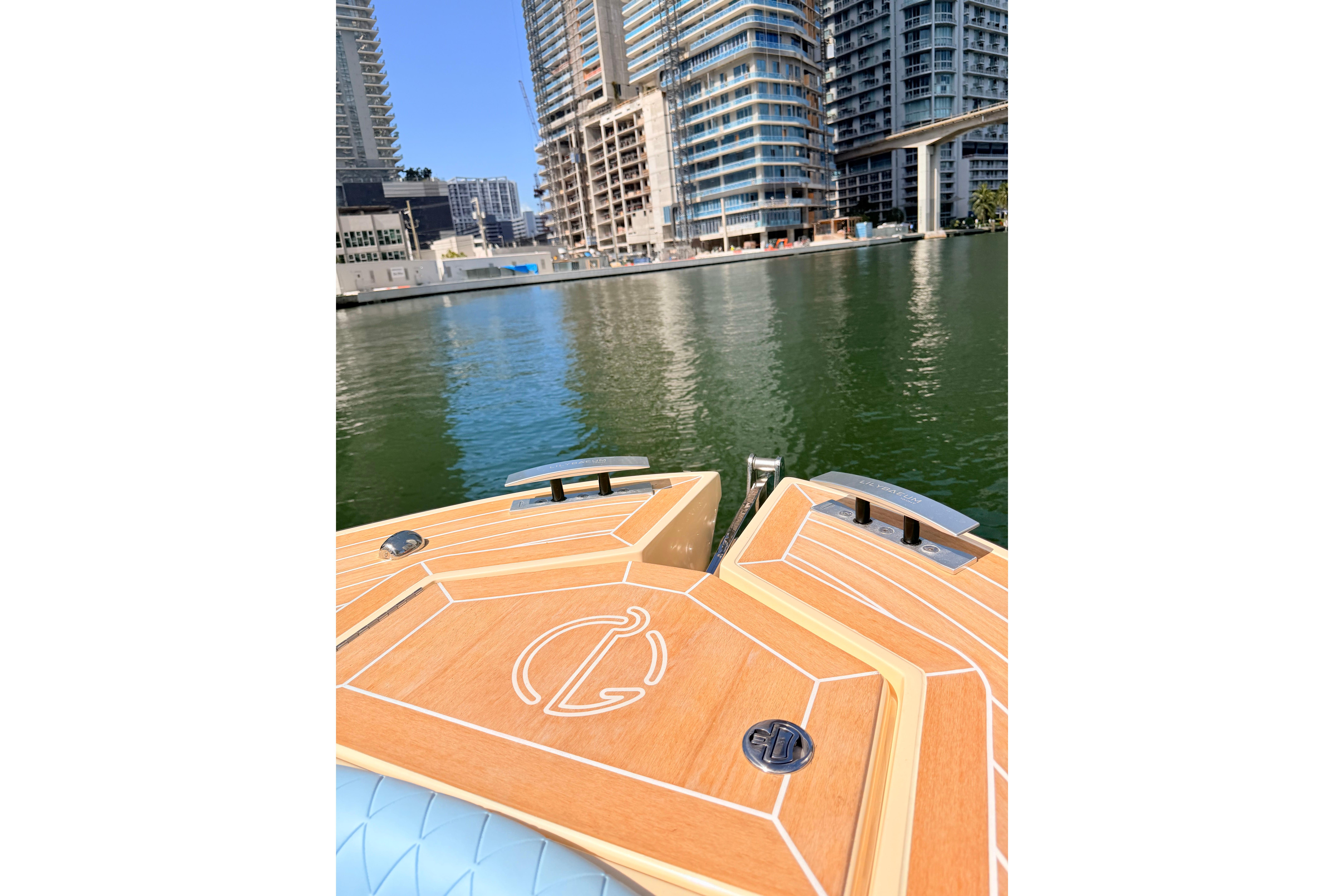 Bow of Lilybaeum Levanzo 25 boat on water, cityscape in background, 2026 model.