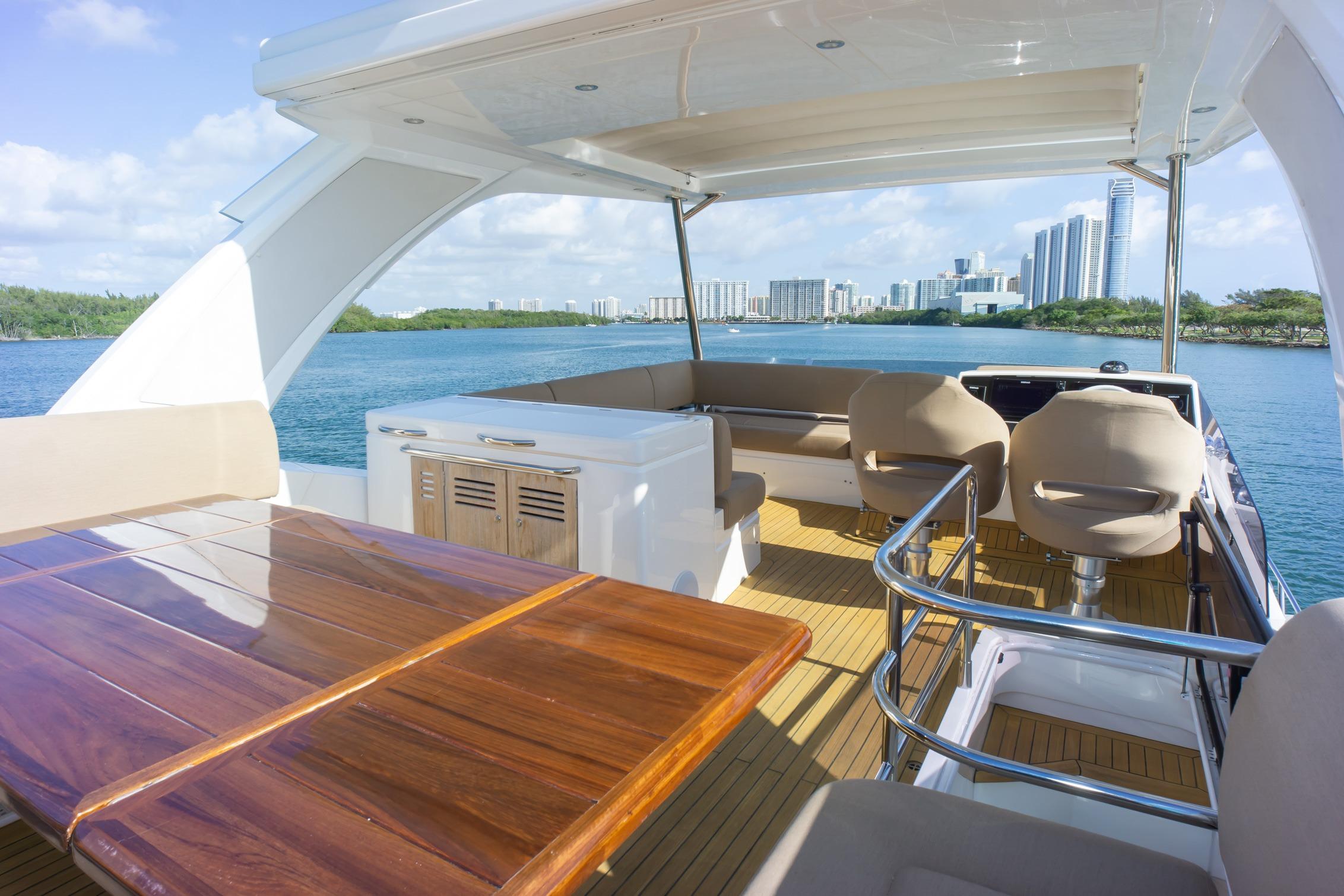 Luxurious 2018 Sunseeker Manhattan 52 yacht interior with scenic waterfront city view.
