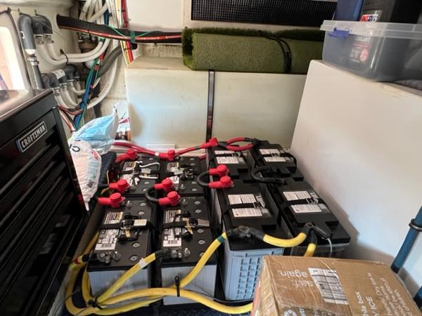 Battery compartment of a 2009 Ovation 52 yacht with multiple batteries and wiring.