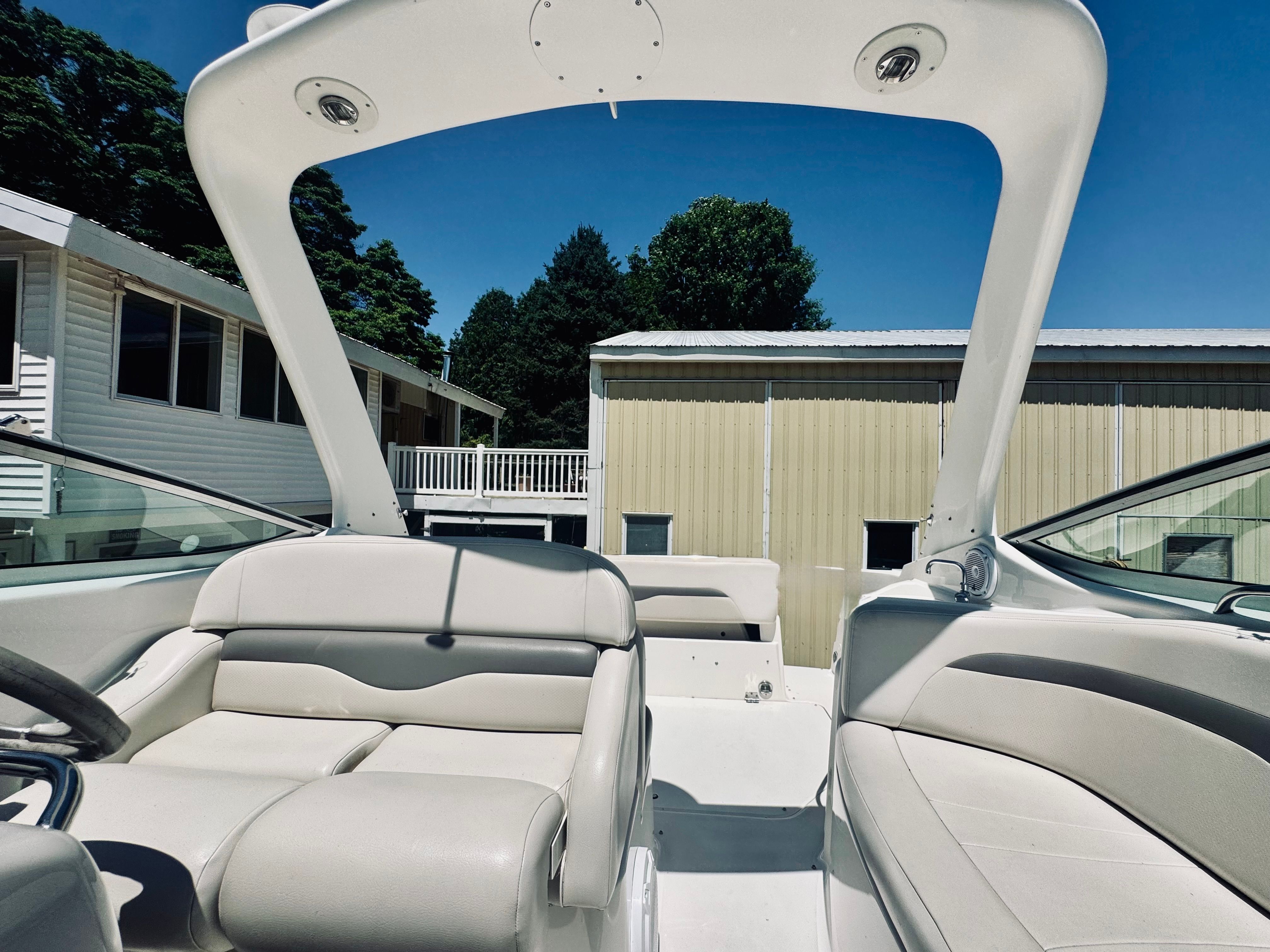 Interior of a 2005 Chaparral Signature 270 boat, beige upholstery.