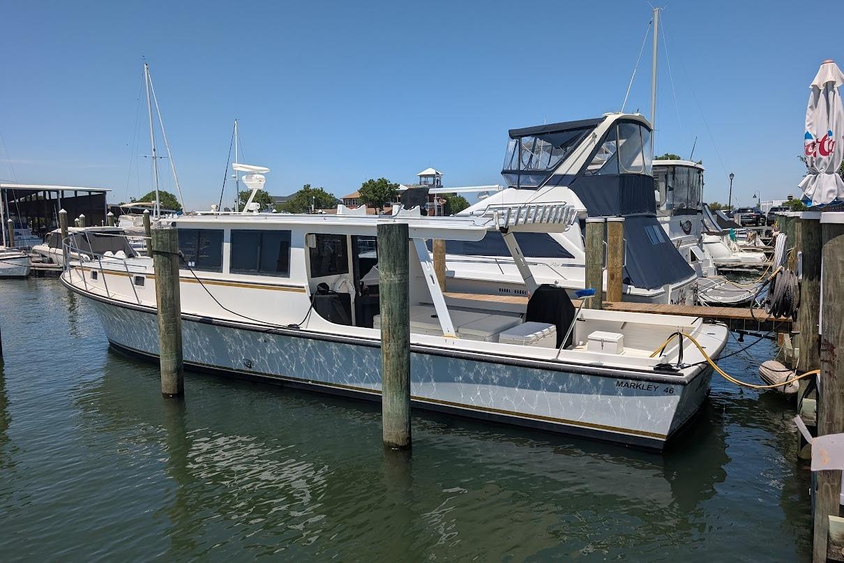 1998 Markley 46 boat docked at a marina on a sunny day.