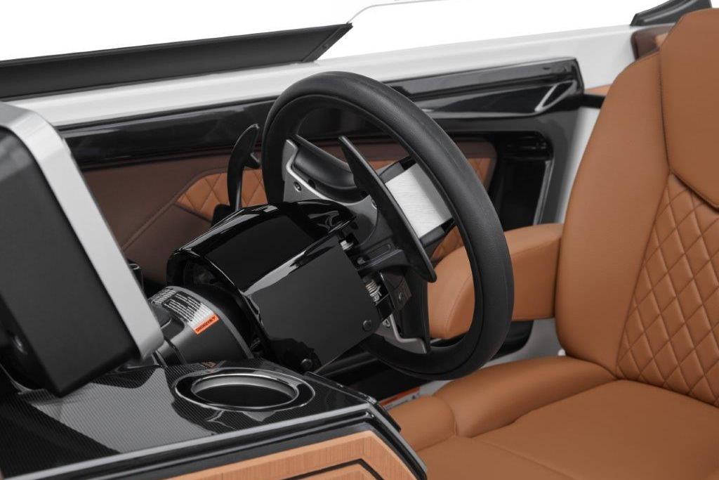 Luxury interior of 2026 Yamaha Boats 252SD, featuring sleek steering wheel and tan leather seating.