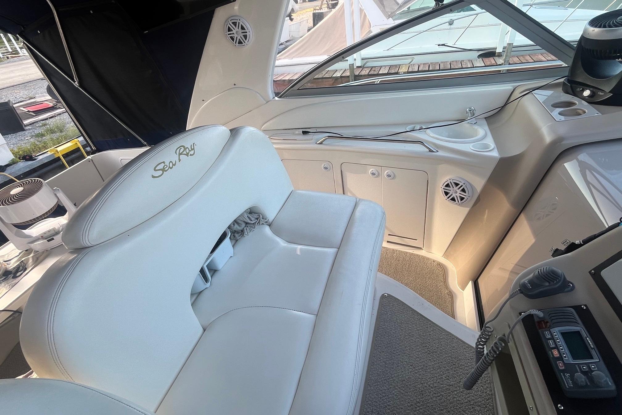 Interior of 2001 Sea Ray 340 Sundancer boat with white seating and control panel.