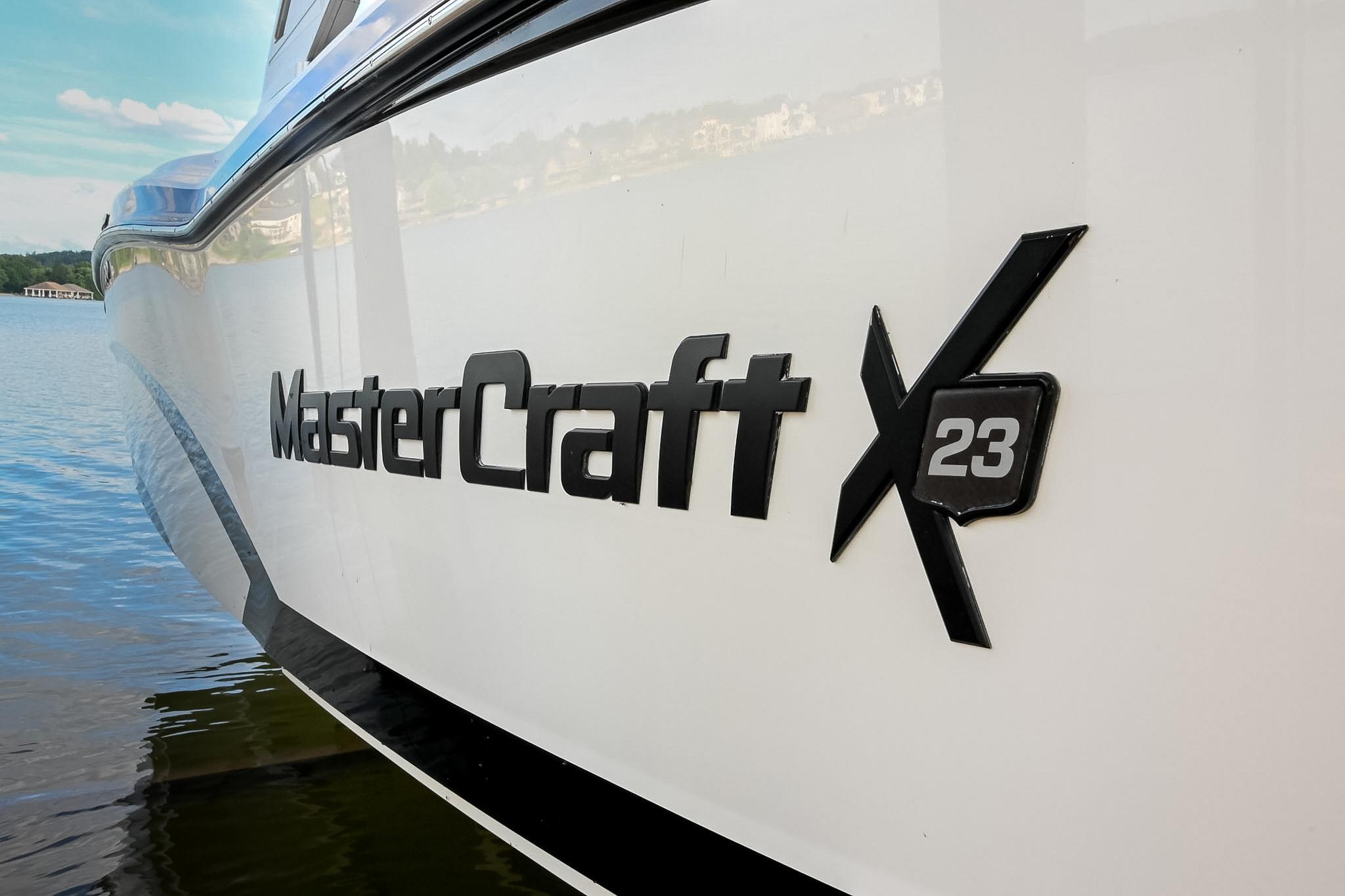 2018 MasterCraft X23 boat on water, showcasing sleek design and branding.