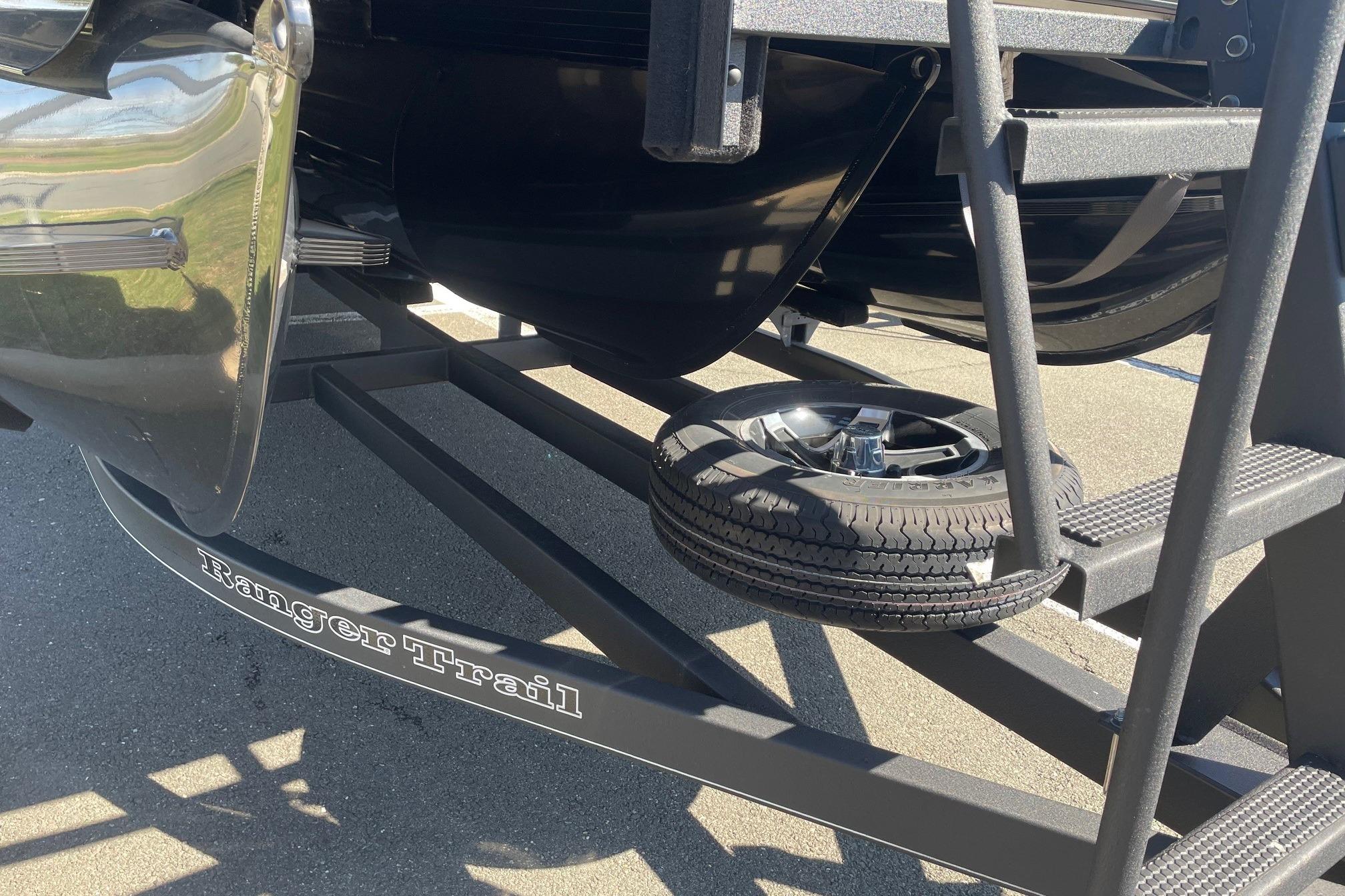 Trailer with spare tire for 2024 Ranger 2500LS boat, labeled "Ranger Trail."