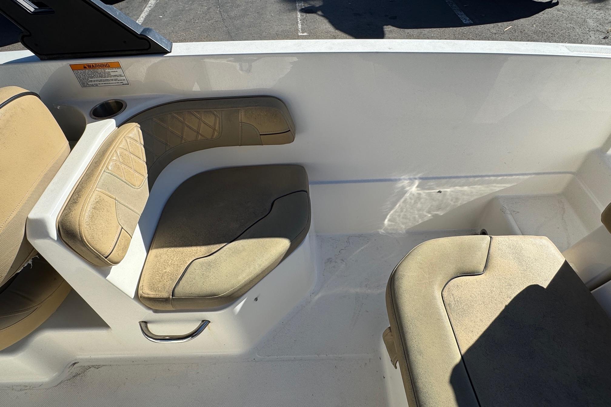 2022 Bayliner VR6 Bowrider OB interior seating with beige cushions and cup holder.
