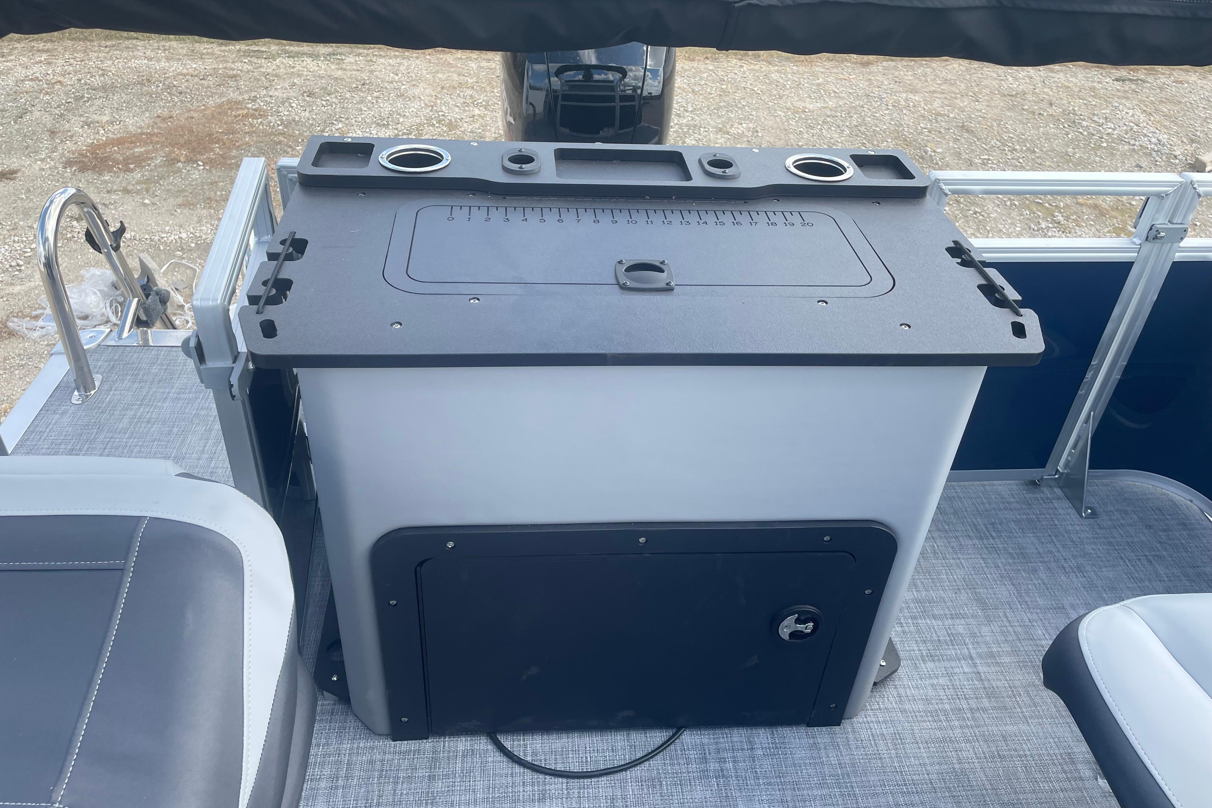 2026 Sun Tracker SportFish 22 DLX boat interior with fishing station and seating.