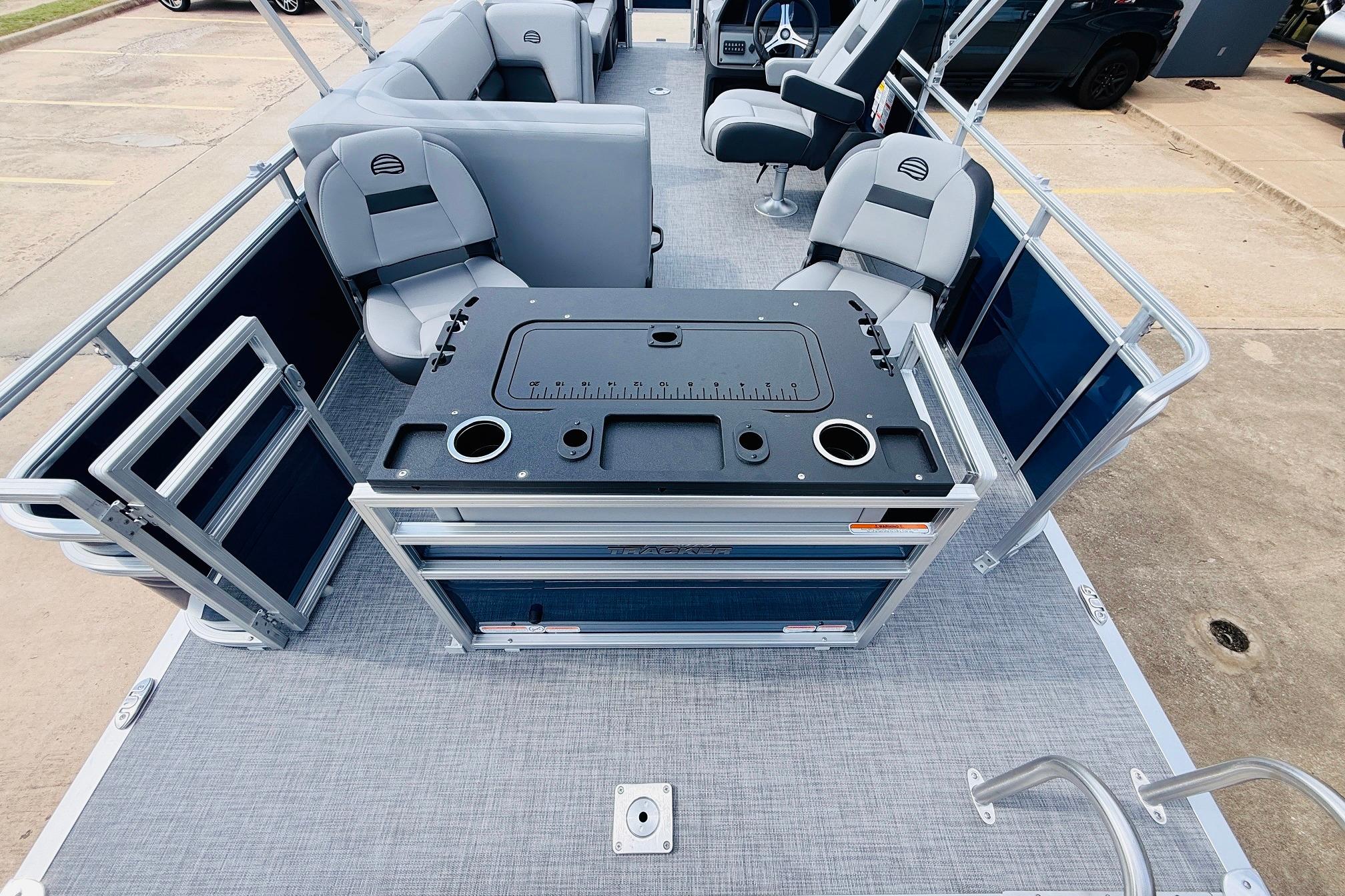 2026 Sun Tracker SportFish 22 DLX pontoon boat interior with seating and fishing station.