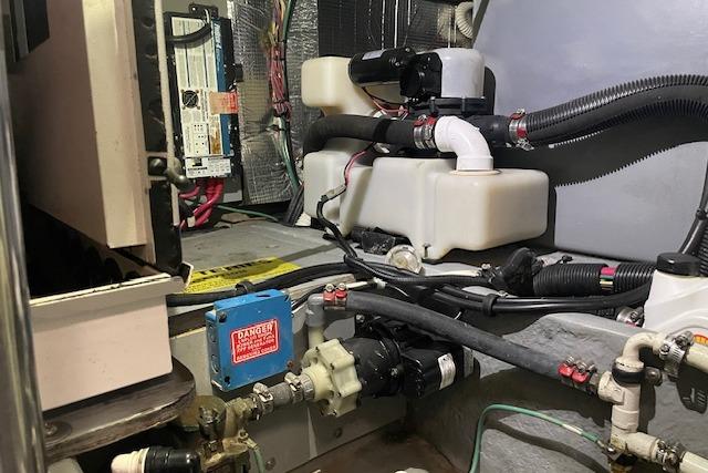 Engine room of 2001 Sea Ray 420 Aft Cabin with various mechanical components and wiring.
